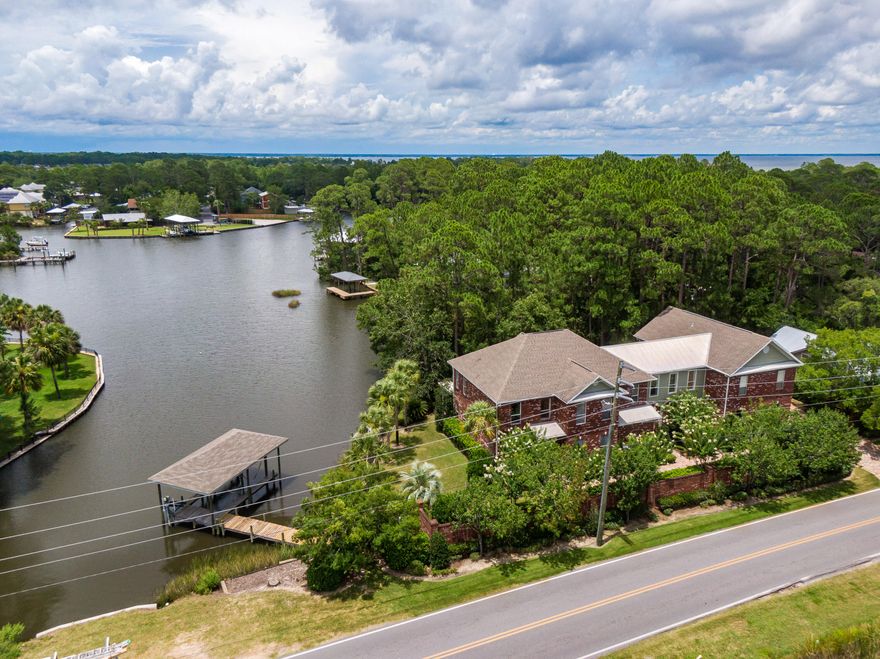 Luxury living in this magnificent custom built home located on a breathtaking lot with 76' of water frontage on deep-water, Buck Bayou. 4202 sq. ft. of classic architecture with luxurious interior detail. This home boasts an additional 1700 sq. ft. of covered porches with exterior living and outdoor fireplace. 
A boater's dream, this waterfront estate comes equipped with a covered boat dock with lift, as well as a jet ski lift. Enjoy the amazing views from the additional sitting dock on the bayou. 
The lower level features the primary bedroom with a spa-style bathroom with two vanities, stand-alone tub and a large walk-in shower, as well as a large walk-in closet. The upper level has 6 additional bedrooms, the library/media room, and a mother-in-law suite with it's own additional access. The upstairs portion with separate entrance is currently set up as a vacation rental and the sale can include the furniture/sheets/towels, etc if desired. 

Kitchen includes brand new appliances (refrigerator, 36" gas stove, and dishwasher) and walk-in pantry. 

Creative/seller financing considered.