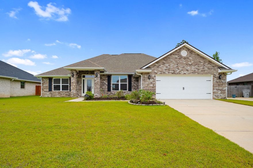 Welcome to this beautifully maintained brick home in Milton, ideally situated just off Hwy 90 and minutes from I-10. Built in 2020, this home boasts a newer roof, HVAC system, and water heater--providing peace of mind and modern efficiency. With 4 spacious bedrooms and 3 full bathrooms, the open floor plan creates an inviting space that's perfect for everyday living and entertaining alike. Step inside to find wood plank ceramic tile flooring and neutral paint tones that offer a fresh, clean canvas for your personal style. The living room is a bright, welcoming space featuring a tray ceiling and ample natural light. Seamlessly connected, the kitchen showcases stunning custom cabinetry, granite countertops, stainless steel appliances, and a cozy dining nook. There's also extra room in the li ving area for a sitting space, offering endless layout possibilities. The split floor plan offers privacy in the primary suite, which features a large walk-in closet and a luxurious en suite bath with a double vanity featuring granite counter tops, a garden tub, separate shower, and water closet. Two additional bedrooms share a hallway bath, while a separate hallway leads to a fourth bedroom and third bathideal for guests or a home office. Practical touches include direct access from the two-car garage into a well-placed laundry room. Outside, enjoy lush green grass in both the front and back yards. The backyard is an entertainer's dream with a covered patio complete with a TV, a firepit, mature landscaping, and a privacy fence. Located on a quiet, clean street, this centrally located home truly has it all!