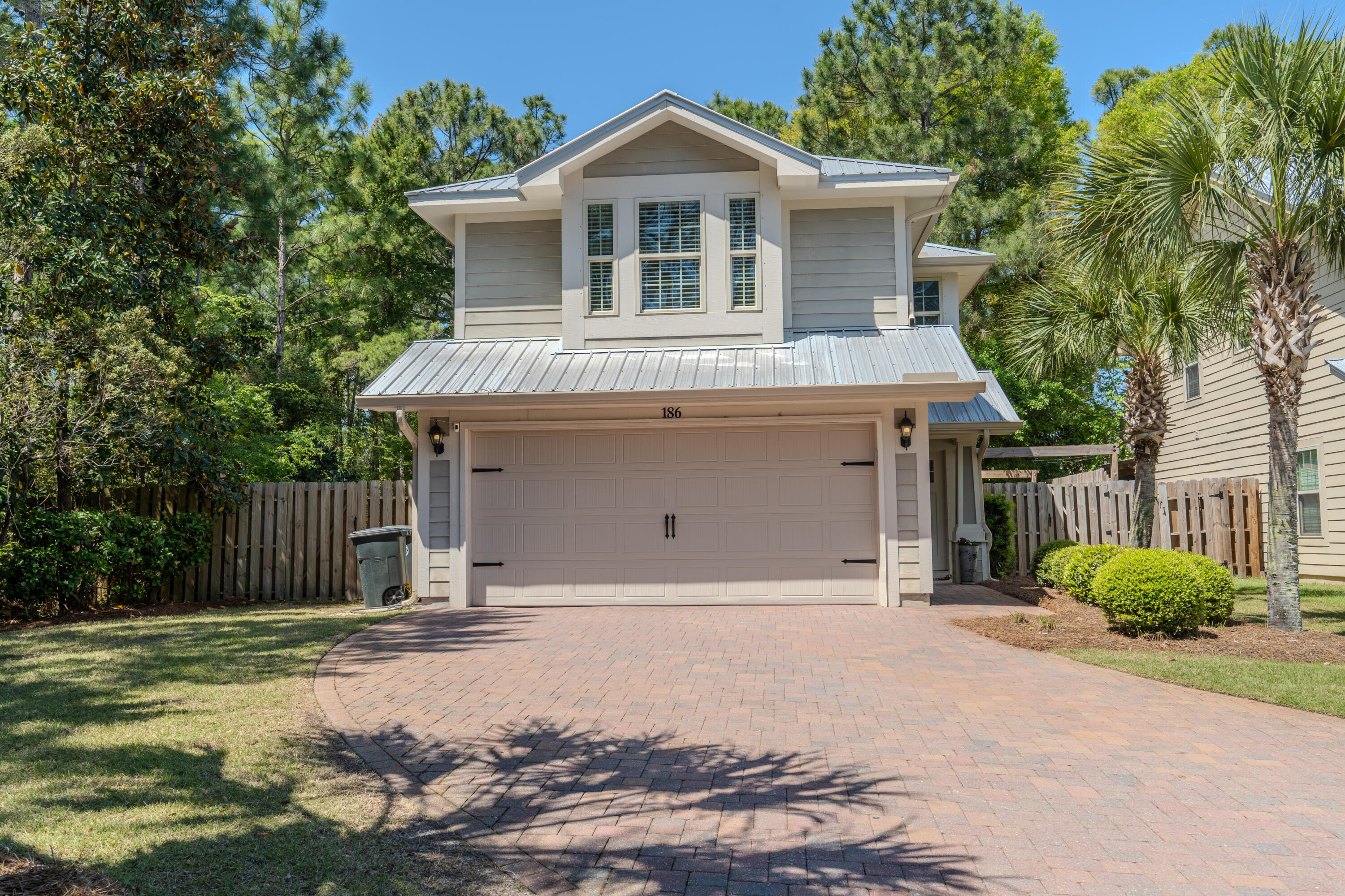 This Florida cottage style home is tucked away onto a quiet cul de sac in Eagle Bay subdivision, conveniently located off East Hewitt and just north of 30A. This home is nestled up against protected forestry offering extra privacy. The first floor features the kitchen, living and dining space and powder room with all bedrooms upstairs. Hardwood flooring has been installed throughout the home. The primary bedroom with en-suite features shiplap siding, walk in shower, double vanity and dual walk-in closets. This home is 1/2 mile to the bay access with boat launch. Some of the amenities of Eagle Bay include paved sidewalks throughout the neighborhood, a lovely common area around the pond and a neighborhood restaurant.