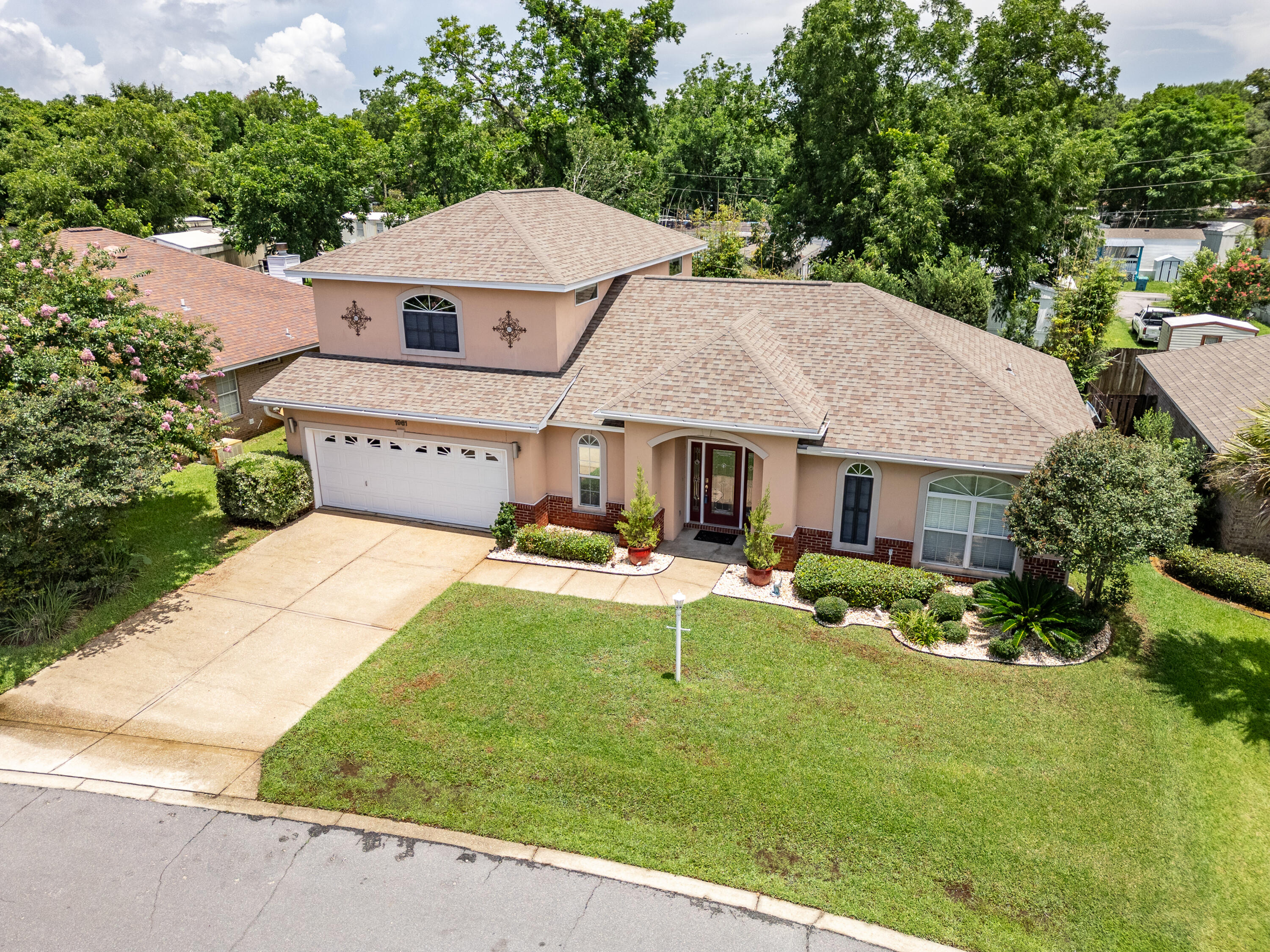 This home is nestled in a beautiful neighborhood between Eglin AFB and Hurlburt Field. Save time and money being so close to everything! This spacious home boasts over 2,700 sq ft! PLUS, no worries about the roof (2021), pool pump (2023) and 2 HVAC systems (2023)! This contemporary home features a first-floor primary bedroom with convenient access to the laundry room. Downstairs, you'll also appreciate the blue tooth, surround sound speaker system, engineered hardwood floors and custom wine bar. Don't miss the sleek gourmet kitchen with breakfast bar, pantry, custom maple cabinets, black pearl granite and stainless backsplash and appliances. Entertaining will be a breeze in the massive great room off the kitchen. Step outside to your private oasis! > You'll enjoy splashing around in your low maintenance, salt system POOL! Lounge around on the deck and no worries about splinters with this composite decking. There's also a natural gas connection for grilling and artificial turf, so no mowing needed out back! Upstairs has so many possibilities - make it 2 bedrooms and a bathroom or a game room or gym or office. You'll also find a convenient walk-in attic storage area upstairs for your out of season items. Quality construction details like impact glass windows, tankless water heater, three-coat stucco claddings and 2X6 framing. Hospital is less than 1 mile away, shopping close by and A+ Liza Jackson is across from the neighborhood. Underground utilities are a bonus too! Don't delay and call your Realtor today!