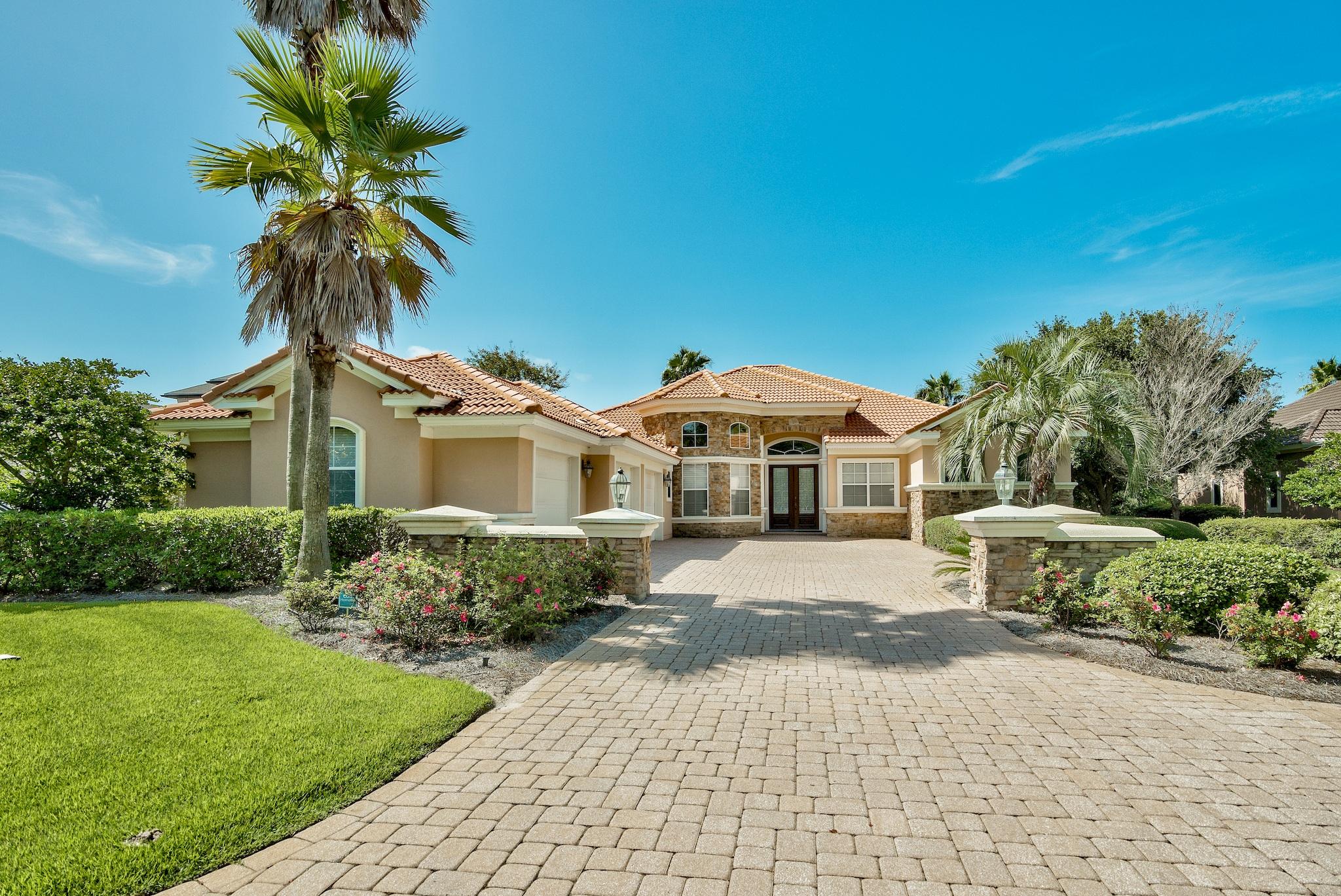 This upscale home in highly desirable Kelly Plantation is a must see! Spacious and grand, the home sits on a large .61 acre lot overlooking the 13th fairway, green, & lake of the prestigious Kelly Plantation Golf Course, and all a short golf cart ride to the beach. Featuring a newly constructed enclosed pool and grand spa, tile floors and granite countertops, a three car garage, and a cozy gas fireplace, this home has everything you could dream of! The luxurious master suite will make everyday feel like a vacation from the comfort of your own home. Three additional bedrooms plus an office/study round out the home and provide plenty of space for the entire family. Updates abound! The pool and spa patio enclosure is brand new, and all pool equipment is less than a year old.