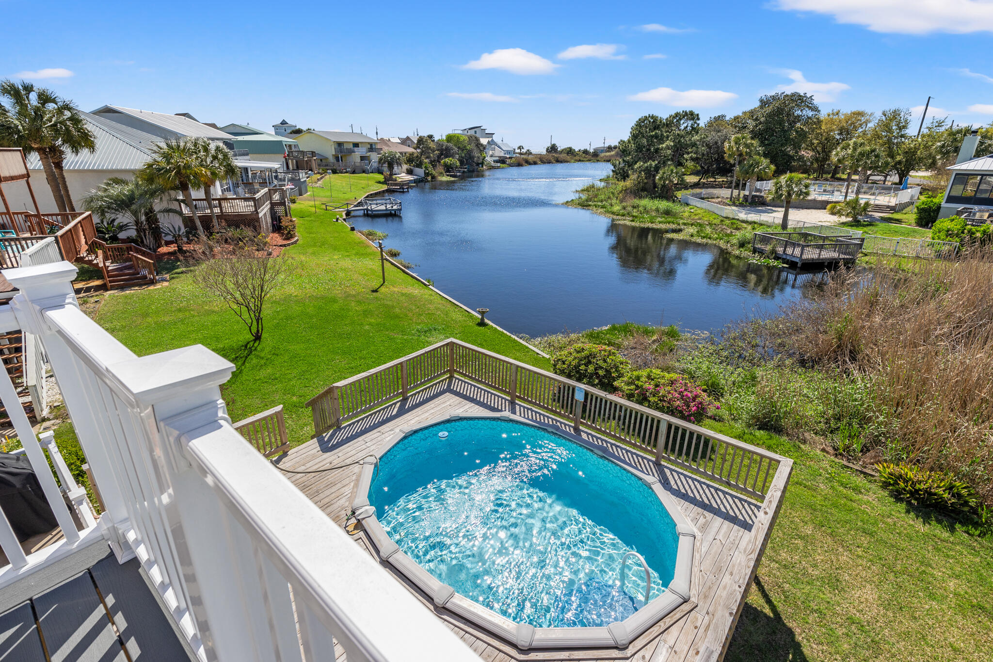 Lake-Front, Pool, Walking Distance to the Beach, No HOA, Fresh 2024 Updates, Fully Furnished, Stunning Views & Amazing ROI! Escape to paradise with this stunning lakefront property nestled in a tranquil setting, just a leisurely stroll away from the sun-kissed shores of the beach. Offering the perfect blend of natural beauty and coastal charm, this home is the ultimate retreat for those seeking the perfect investment beach home with above average ROI 80k+!, 2nd home or primary residence. You will love the open concept with an abundance of natural light and amazing views. New updates like, granite counter tops in the kitchen and all baths, custom soft-close cabinets, luxury vinyl plank flooring, fresh interior & exterior paint, new deck with a phenomenal view and more! Large master bedroom