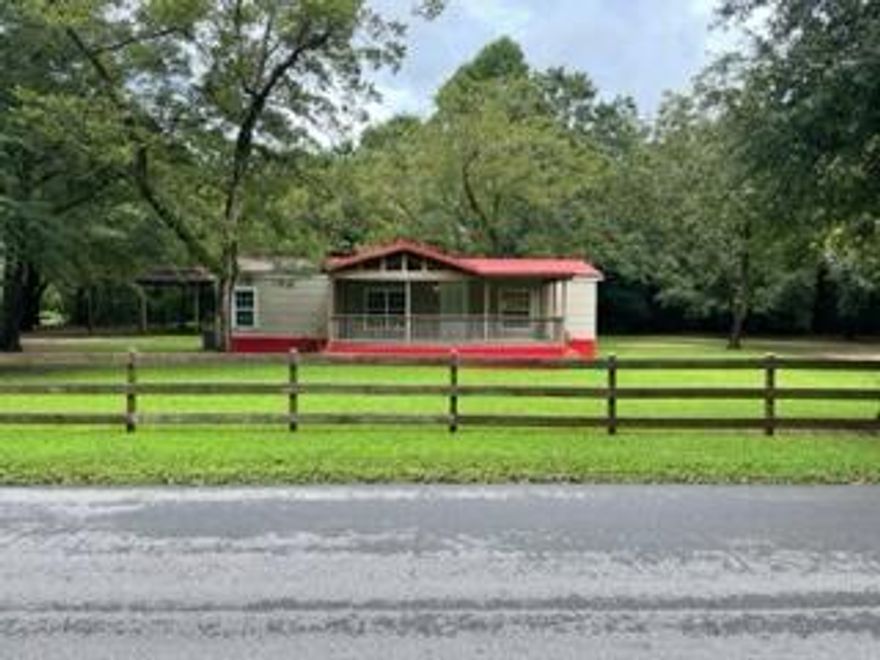 Country home with plenty of shade and big fenced in yard. Excellent location on 1 acre corner lot with paved rd access. 3/2 with large porches on front and back.  30X36 pole barn in the back.  Call today for showing