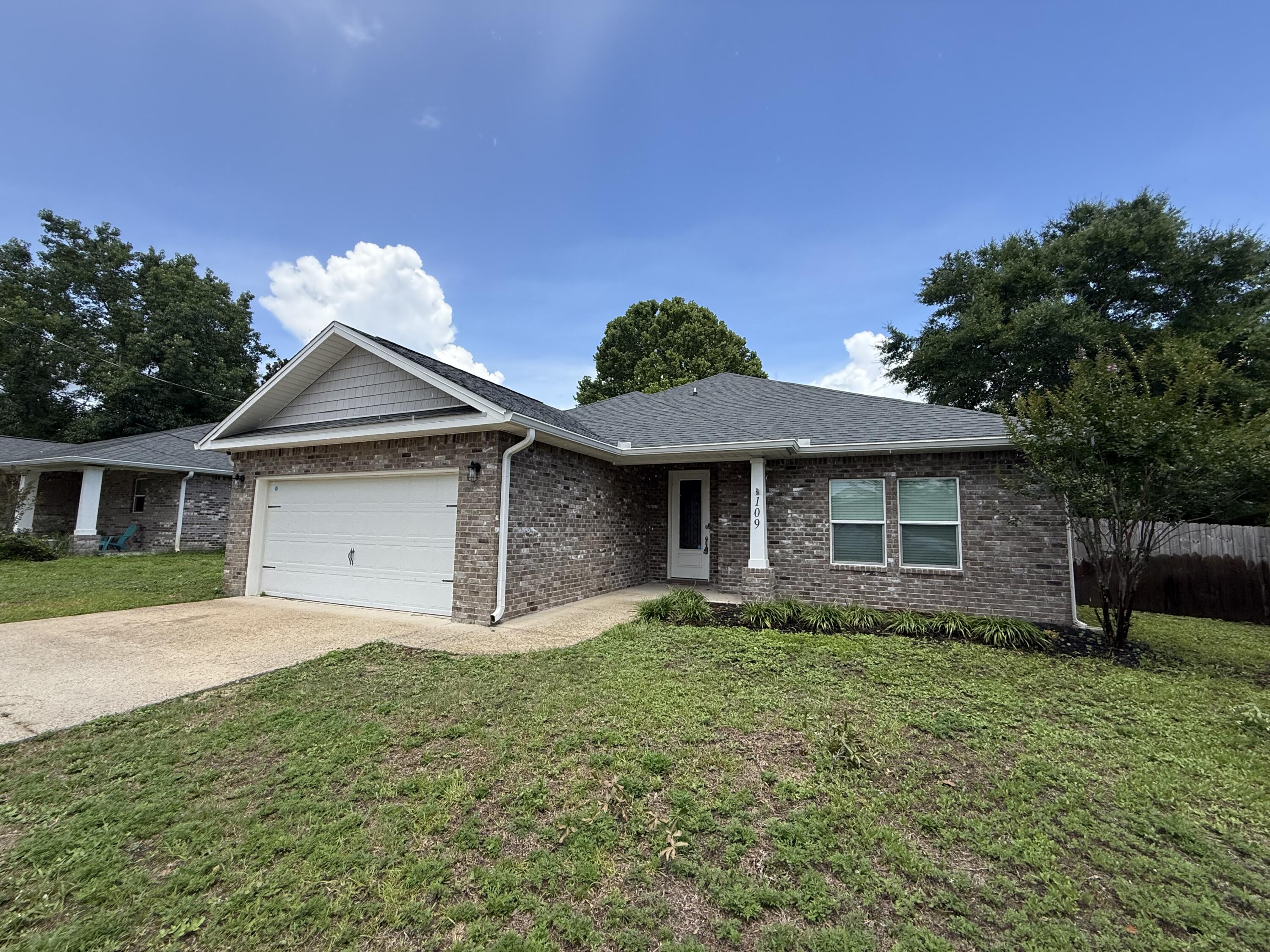 Welcome home to this stunning 3 bedroom, 2 bath nearly new home in Mary Esther with no HOA! Conveniently located on the Emerald Coast and a short commute to Hurlburt Field you'll love this beautiful property which has all the updated finishes you've been looking for. The kitchen is a dream featuring granite countertops, a convenient breakfast bar, elegant wood cabinets and hardware, and quality fixtures like soft close drawers. Wood-look tile floors flow seamlessly through the foyer, kitchen, baths, and laundry room, adding warmth and durability throughout the home and you'll absolutely love the double trey ceiling in the spacious living room adorned with crown molding. The master bedroom is generously sized with another trey ceiling and you'll enjoy relaxing in the master bathroom where you'll find a walk in shower, a tub, two walk in closets, a water closet, and double vanities with granite counters. The other two bedrooms on the other side of this split bedroom floor plan are great sized rooms with ample closet space, and the full bathroom between them also has double vanities! Step outside onto the expansive 10x20 back porch, perfect for morning coffee, evening relaxation, or entertaining guests. This home is perfectly situated just minutes from the stunning Emerald Coast beaches and ready for you to call your new home!