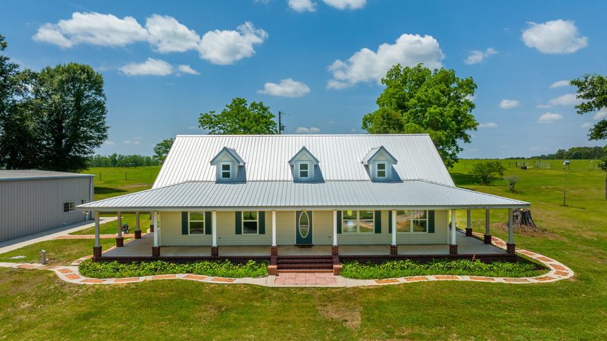 North Walton County, Florida Paradise! Out of town, but less than an hour to the World's Most Beautiful Beaches! Come and see this Ranch Style 3bdrm/2ba. 2014 sq. ft. heated and cooled home with wrap around porches (3900 sq. ft. under roof).  Open floor plan with skylight dormers, cathedral beam! New flooring and new stainless appliances, This 10+ acre parcel has 5 acres on each side of road with wooded area for hiking trails, stream, hunting, orchard with pear, satsuma, persimmon, and pecan trees! A 2400 sq. ft. red iron metal building sits next to home with 1600 sq. ft. of shop area plus an 800 sq. ft. 2 bdrm. 1 bath apartment/suite.  40x40 antique pole barn sits beside shop. Beautiful contoured yard with large live oaks! Massive storage loft in shop. RV hook ups between shop and house.