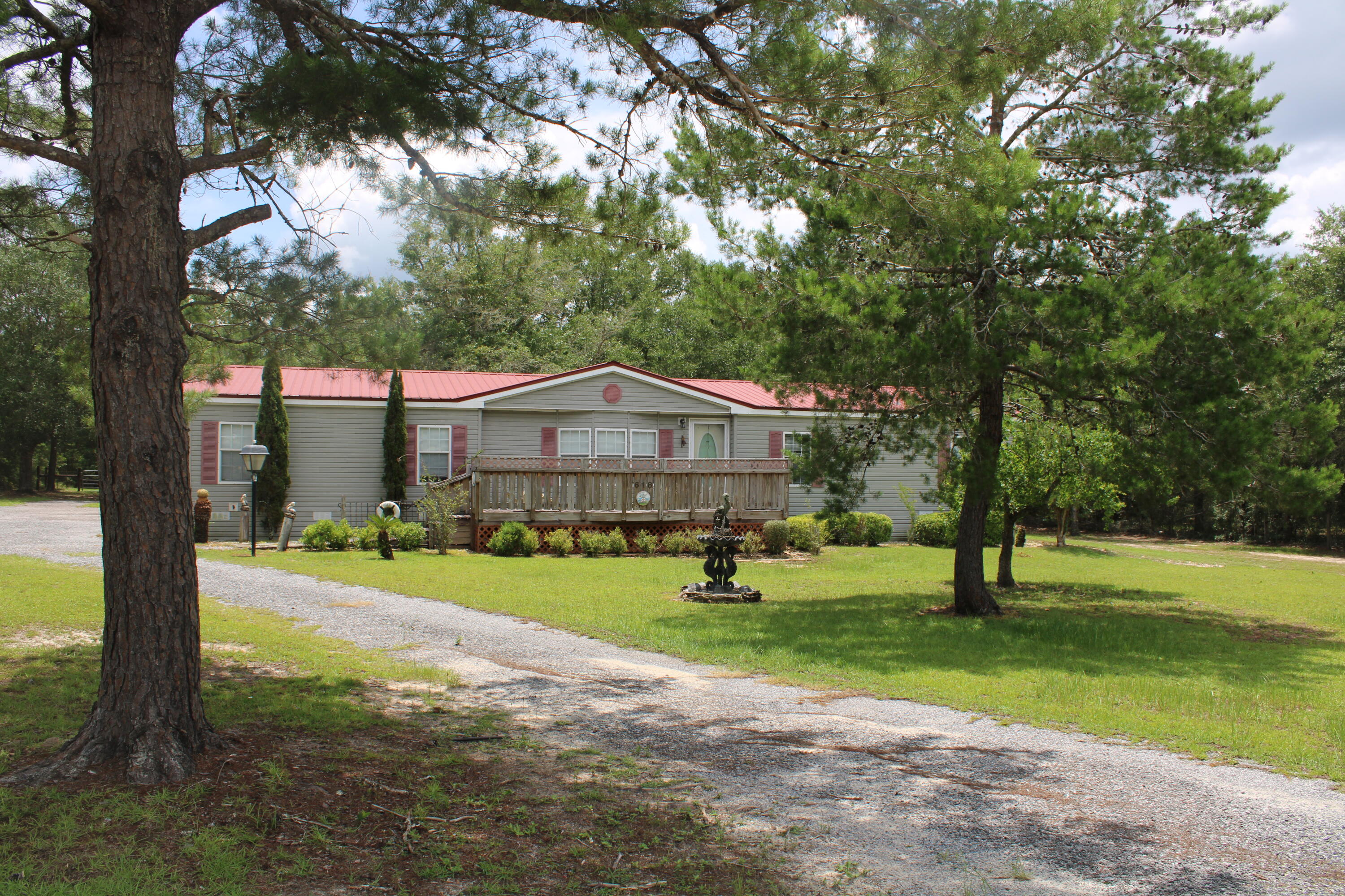 Well-maintained 2002 custom Fleetwood manufactured home nestled in the peaceful countryside of DeFuniak Springs. This spacious 3-bedroom, 2-bath home offers a comfortable and functional layout.Step inside to discover a light-filled interior featuring a large living area, an open-concept kitchen with ample cabinetry, and a dining space ideal for family gatherings. The split floor plan offers privacy, with a generous primary suite including a walk-in closet and ensuite bath. Two additional bedrooms and a second full bath provide plenty of space for guests or a growing family.Enjoy the quiet of rural living on nearly an acre while still being within a short drive to town conveniences, schools, and I-10.