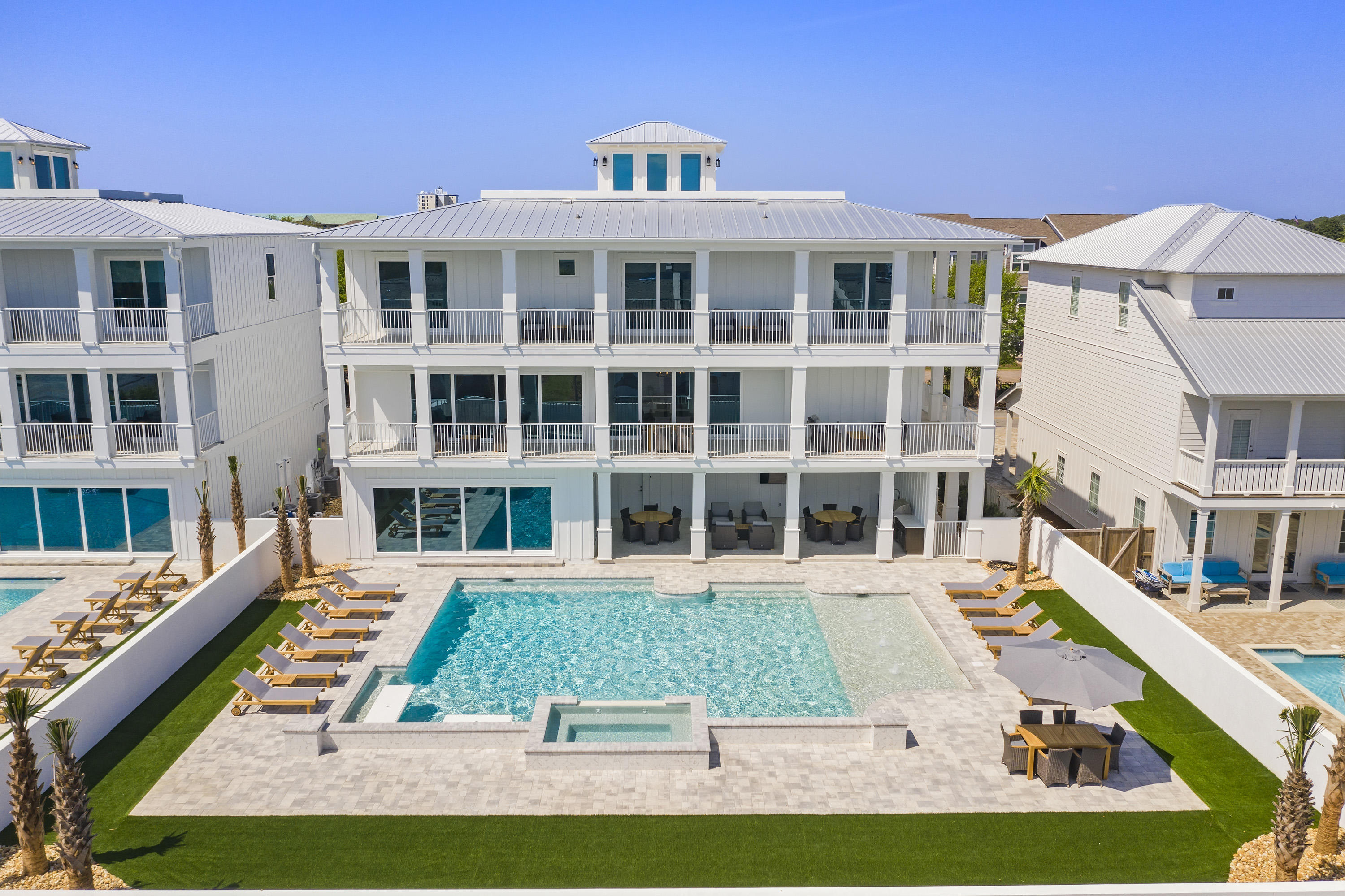 Introducing ''Hypnautic,'' a newly constructed 6,333-square-foot 8-bedroom designer showpiece with stunning coastal interiors, state-of-the-art amenities, and a resort-style pool. This luxury beach home is already a significant income producer with $265K in projected annual rental income. No mandatory HOA dues. Open-air comforts include a custom-designed LED-lit pool with sundeck, elevated spa, summer kitchen, covered outdoor dining, four terraces, and rooftop deck, offering sensational sunset vistas. Lifelike synthetic turf provides zero maintenance and year-round beautification. This home has all the essentials for entertaining: ample parking, large gathering spaces, seamless indoor-outdoor flow, and a lavish chef's kitchen - plus a private movie theatre and fully equipped game room