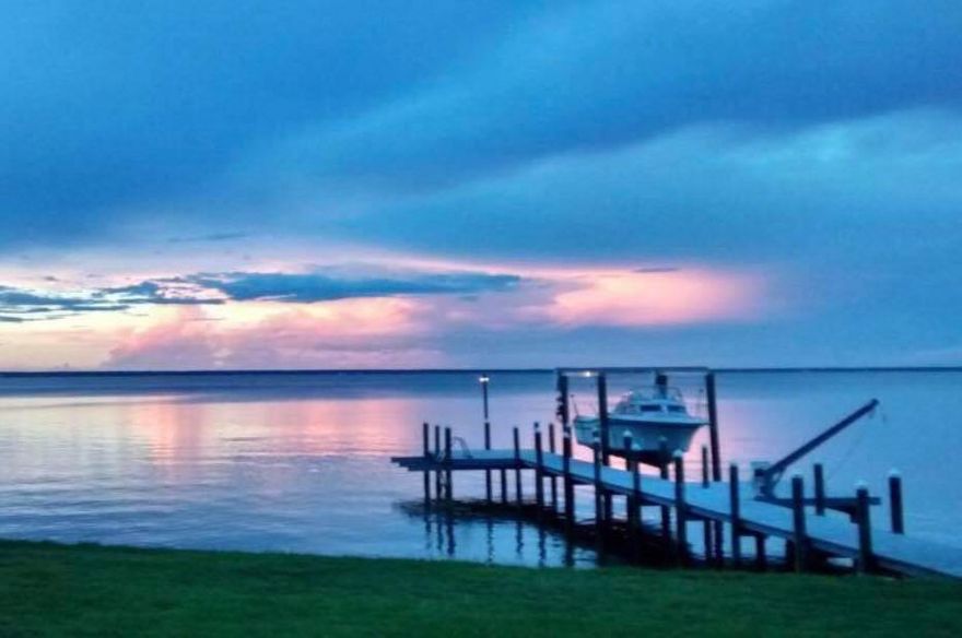 Price reduced for quick sale. Beautiful bay front, award winning, custom built home is ready for a new owner. This 3 bedroom 2.5 bath home is beautifully situated on 85 feet of bay frontage. This home features an open floor plan, granite counter tops and custom cabinets. The eight foot wind-rated garage door offers extra protection and allows for large, over-sized vehicles. The living room feels extra spacious with cathedral ceilings. The master bedroom features a gorgeous bay view, large walk-in closet and a tray ceiling. Other home upgrades include: WaterFurnace geothermal HVAC system, storm shutters, house generator, central vacuum system, built-in bug deterrent system, irrigation system and security system. Refurbished dock also includes a boat lift.