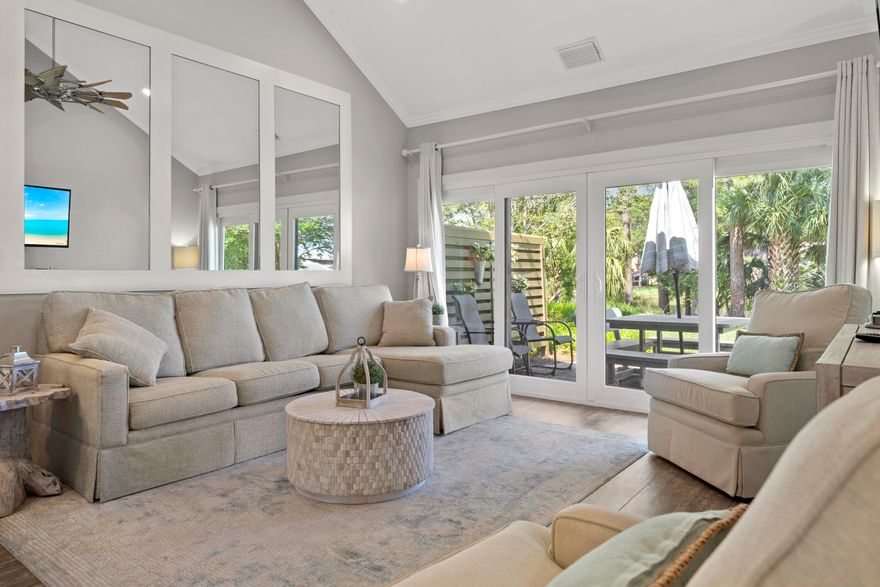 SPECTACULAR, FULLY RENOVATED END UNIT overlooks lake & fountain on the BEACHSIDE w/HUGE YARD!  Over $100K in improvements in the last 12 mo!  Literally everything has been renovated including: AC in 2021, HWH in 2018, replumbed, ALL new LOW e high impact doors & windows 2022 ($30K), all new solid core doors, custom trim incl shiplap & board and batten walls, extended kitchen w/white cabinets, tile BS, quartz counters & SS appl. incl wine fridge! Outside closet enclosed for new indoor laundry/pantry.  Both baths totally renovated. All new lighting, scraped ceilings,  plumbing fixtures, it's literally all been replaced.  Refurnished in 2021,  including new queen sleeper sofa with Crypton high performance fabric.  Current owners keep 3rd BR locked for personal use and rent it as a 2 BR.