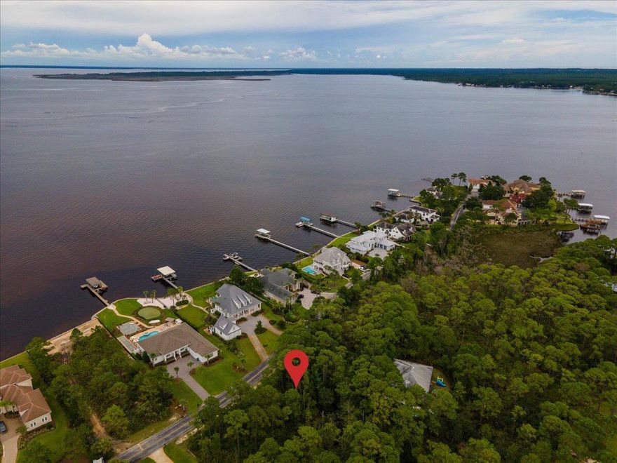 Behind the gates of this private Grand Cove estate, you'll find a wooded half acre lot surrounded by beautifully custom built homes. Don't miss out on the opportunity to build your personal oasis and wake up each morning to breath taking corridor views of the sun rising over the Choctawhatchee Bay. Driftwood Estates is perfectly located with quick access to premier shopping, dining & entertainment. Spend the day shopping & dining at Grand Boulevard or Silver Sands Premium Outlets, or relax on the sugar white beaches along 30A. Everything you'll need to enjoy coastal living is right at your fingertips including nature trails great for biking, the bay or gulf for swimming, paddle boarding or kayaking, and parks for picnics.