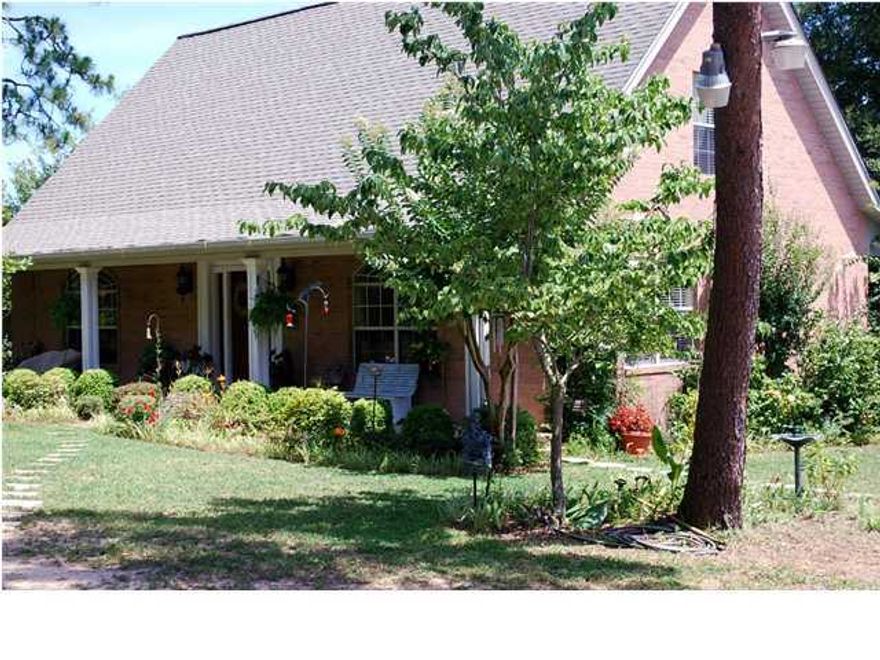 Poquito Bayou's best kept secret! Private and peaceful. Charming all brick 3 bedroom 2.5 bath home tucked away amid beautiful trees and flowers. The spectacular oak hardwood flooring perfectly stages the kitchen, dining and living room's open floor plan, while the large arched windows provide ample natural lighting with views of the landscaping. The kitchen features tiled countertops and breakfast bar, and all-wood oak cabinets with under- cabinet lighting and lots of storage. The large master bedroom and bath are privately situated at one end of the house. The spacious Master Bath features a walk-in shower, beautiful claw foot tub, sink housed in an antique cabinet, and a walk-in closet. The beautiful hardwood staircase leads
