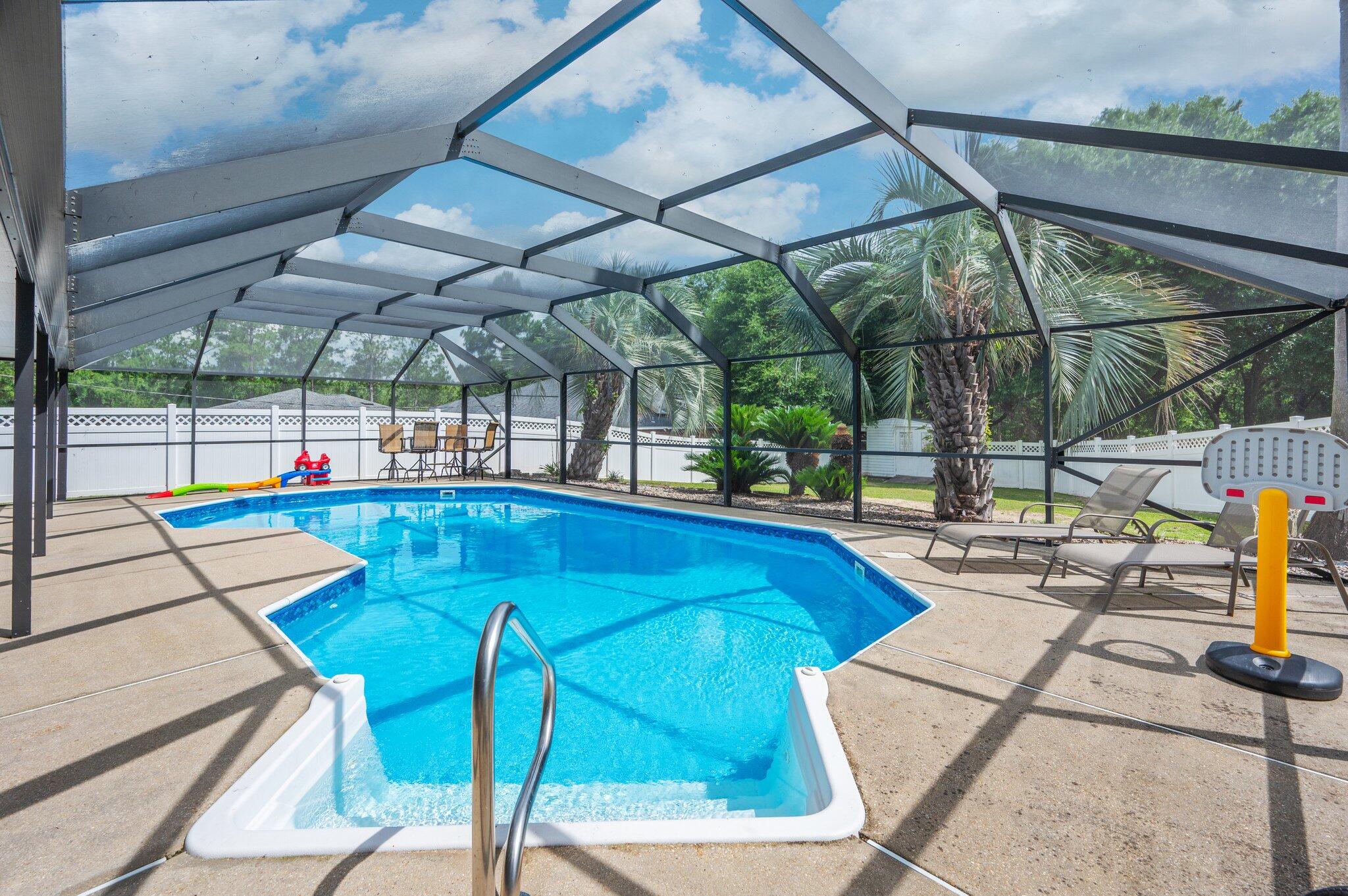 Tropical Vibes + Pool Life = Home Sweet Home! Just south of I-10 & close to the bases, this 4BR/2BA stunner has everything you've been dreaming of- Starting with your very own in-ground pool Oasis w screened enclosure (new screens 2024) framed by tropical landscaping. Inside, FRESH & UPDATED (most 2024) LVP, granite counters, tiled backsplash, new appliances, and a dreamy primary suite with separate shower & soaking tub. Cool tech upgrades? Ring doorbell & cam, smart garage door, smart switches, & a wifi sprinkler system w rain sensor to keep your lawn looking sharp. OUT BACK: white vinyl fencing, storage shed for tools & toys, and space to relax or entertain. Water heater (2023), Roof (2021), HVAC (2014) Kevlar fabric hurricane protection for windows & sliding door. LOCATION? Prime. POOL? Perfection. Ready to Dive in? Message us today for a showing!!!