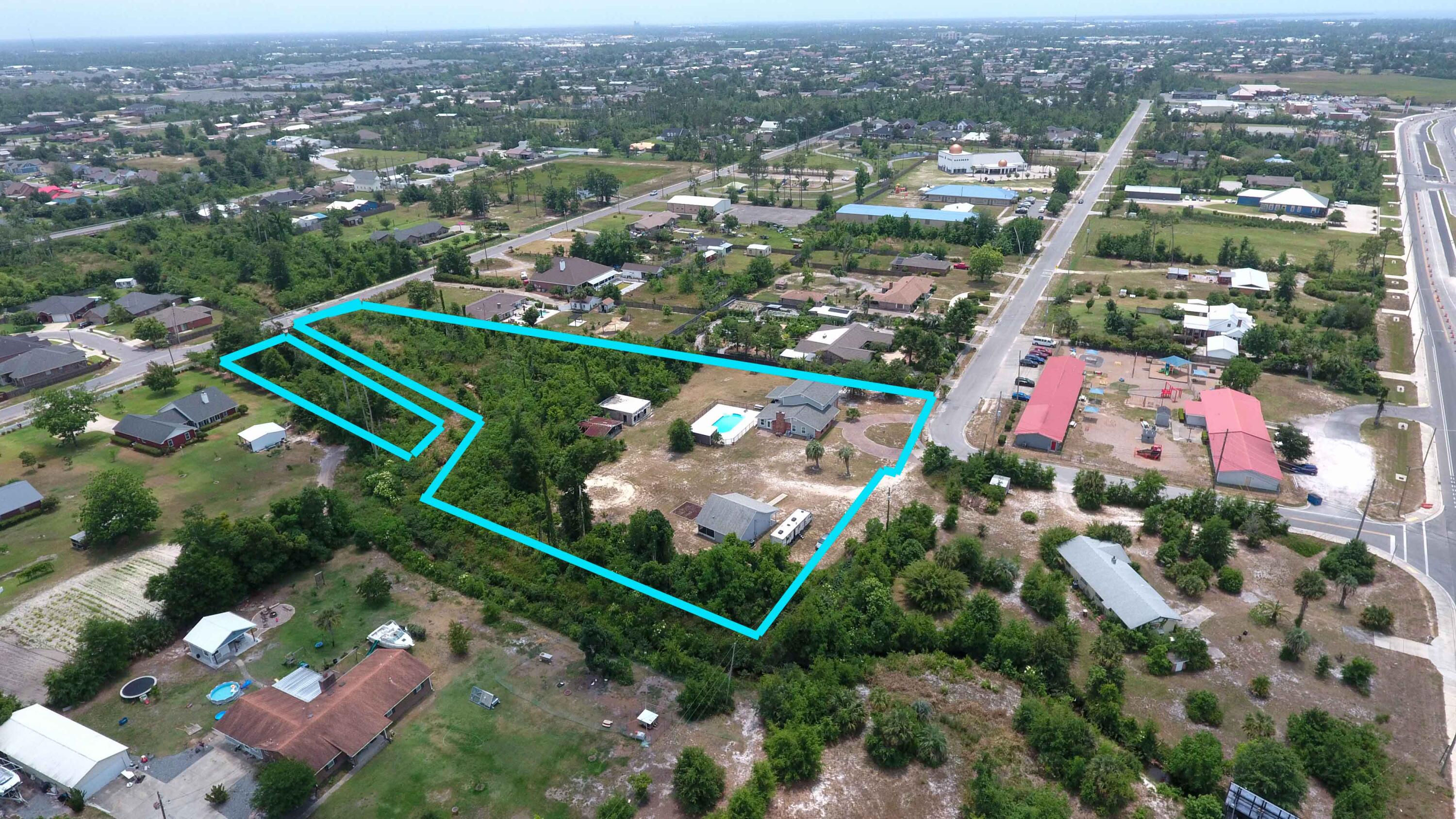 3 Acres in middle of town with a Totally Renovated home with a mother in law quarters and a Pool!!! This is it! Come see this beauty today. This home is Stunning open floor plan with, Custom kitchen, spacious living room, dining area, Pool room/ Family room, sun porch, 2 master suites one upstairs and one down stairs. Laundry off the closet in the Master! This home has 2 fireplaces, Vinyl plank flooring in main living areas and carpet in bedrooms a Bar area, so much space!!! This home also has an adorable mother in law quarters that was built in 2018 that has 2 bedrooms and 1 bath perfect for the aging parent, or young college student, or you could rent it out to help off set your mortgage. These homes sit on almost 3 acres of land that stretch from Token road all the way through to Florida Ave. There are 2 barns on the property that were damaged in Hurricane Michael and never taken down but the bones are still in tact for someone who wants to re do them.
Enjoy the evenings swimming in the in ground liner pool or sit under the back porch and watch the kids play in the pool. This home has a little bit of everything! You don't want to miss this one!