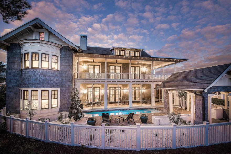 Set on an over sized lot overlooking the Yacht Pond at WaterSound Beach, this professionally decorated home is move-in ready. French doors lining the living and dining areas capture views of the Yacht Pond beyond the outdoor entertaining area onto which they open. A spacious screened porch overlooks a 34-foot lap pool with adjoining patio whose tabby fire pit runs almost its entire length. The built-in gas grill is sheltered by a shade-casting pavilion. The 1st floor master suite enjoys access to the screened porch and includes a private study, deep walk-in closet, a truly impressive number of built-in cabinets and drawers, as well as an exceptional spa bath with 3-head walk through glass tile shower, claw foot soaking tub, and twin vanities.