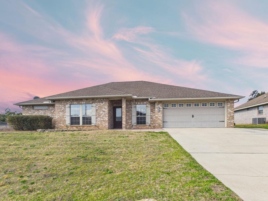 Located in the Lee Farms subdivision, 5452 Lee Farm Blvd is an all-brick pool home that perfectly balances aesthetics with a layout designed for effortless entertaining. Ideally situated for a seamless commute to Hurlburt Field, Duke Field, and Eglin AFB, this residence welcomes you with soaring 9-foot ceilings and a modern color palette. The interior features a refined mix of durable wood laminate flooring in the primary living areas and master suite, complemented by sleek porcelain tile in the bathrooms and laundry room. At the heart of the home, the gourmet kitchen is a chef's delight, featuring rich cabinetry, stainless steel appliances, a center working island, and breakfast bar seating for casual dining. The thoughtful split-floor plan offers a private guest wing accessed through  elegant French doors, revealing a spacious 18x12 second family room. This versatile suite includes its own bedroom and bathroom, along with private access to the patio, making it an ideal space for multi-generational living or a secluded home office. The primary retreat is equally impressive, boasting a spa-like European-style bath with dual vanities and a deep soaking tub. Step outside to find a true backyard oasis designed for ultimate Florida living. The meticulously maintained grounds feature a pristine ozone pool with an integrated spa, all framed by a sprawling paver patio and a charming pergola perfect for shaded relaxation. A dedicated storage shed and a fully fenced yard complete this private sanctuary. Schedule your tour today!