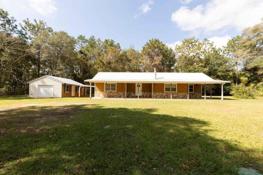 Have a look at this quaint home just outside of town on over an acre! Imagine sipping your coffee each morning on this beautiful front porch! This 3 bedroom, 2 bath home has newly stained hardwood floors, wood burning fireplace, freshly painted walls, interior laundry with washer and dryer, and would be a great place to call home! Smaller bedroom has an added loft area for extra space! The detached 1 car garage is wired with outlets for use as a workshop and has an attached carport and greenhouse space! Whirlpool appliances and Maytag washer and dryer convey as is. Metal roof replaced 2015, garage door replaced 2019. Buyer to verify any and all information deemed important, including measurements and zoning.