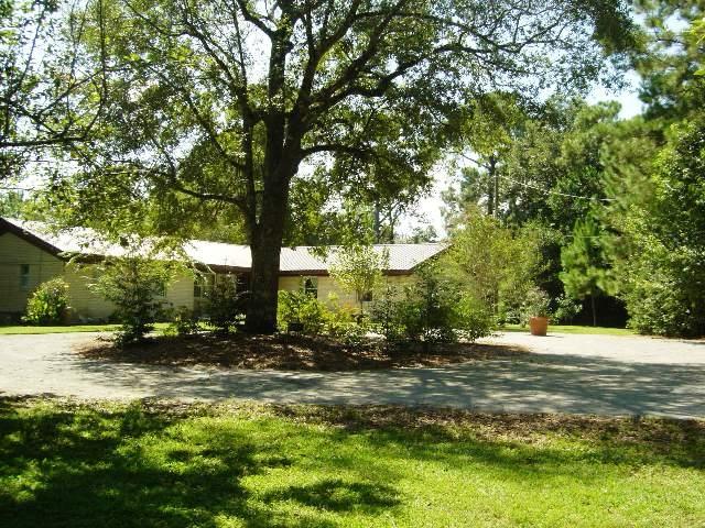 A RARE FIND! The only property available on Lake Stanley with water front on three sides. Three well manicured lots included; waterfront on Lake Stanley, Back Lake and a channel connecting the two lakes with more than 500 feet of waterfront. Very private setting in the city with a variety of mature trees, shrubbery and plants that add to the beauty and serenity of this home. A boathouse, boardwalk, dock, tool garage and gazebo are just a few of the unique features adding to this outdoor paradise. The home has a new metal roof, new windows, heat & air unit and lots of room for the family. For your guests there is an attached 4th bedroom/great room and bath that is accessible from a separate entrance. You will not find another property like this! Seller is providing a home protection plan