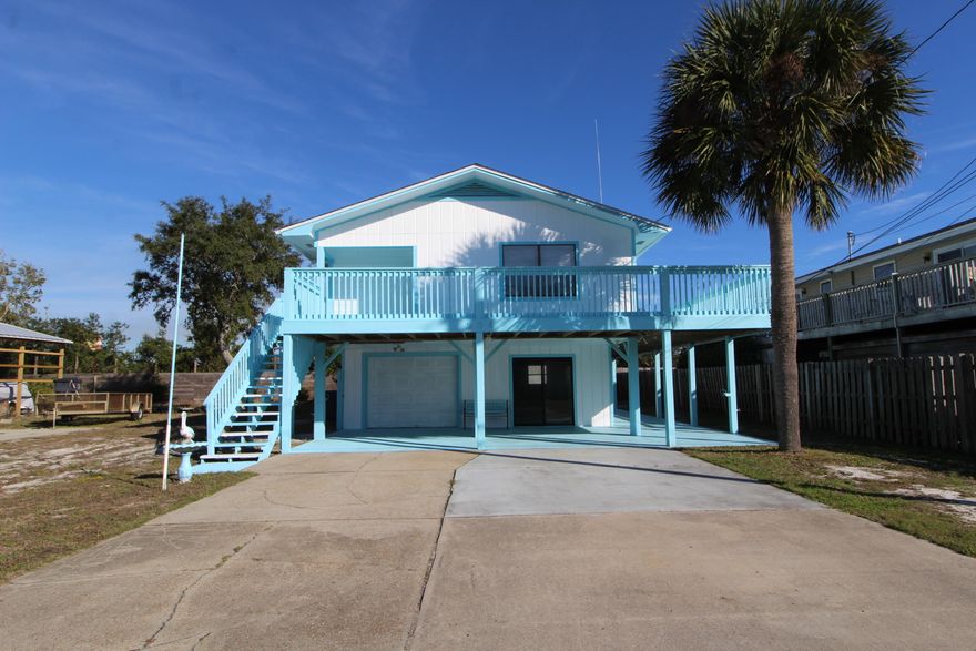 Enjoy the Florida lifestyle in this light and airy 2 story property. Plenty of fun in the sun to be had as the property is convenient to the beach, shopping, and other exciting activities. The home has a wonderful lay out, perfect for entertaining. The kitchen/living room area is open and has direct access to the large balcony. The entire second floor allows for a lot of natural light to come through. The bottom floor has plenty of room to park a vehicle and additional storage. Plumbing is available downstairs as the washer and dryer space is located there. 2 Large yard buildings convey. AC installed in 2014.