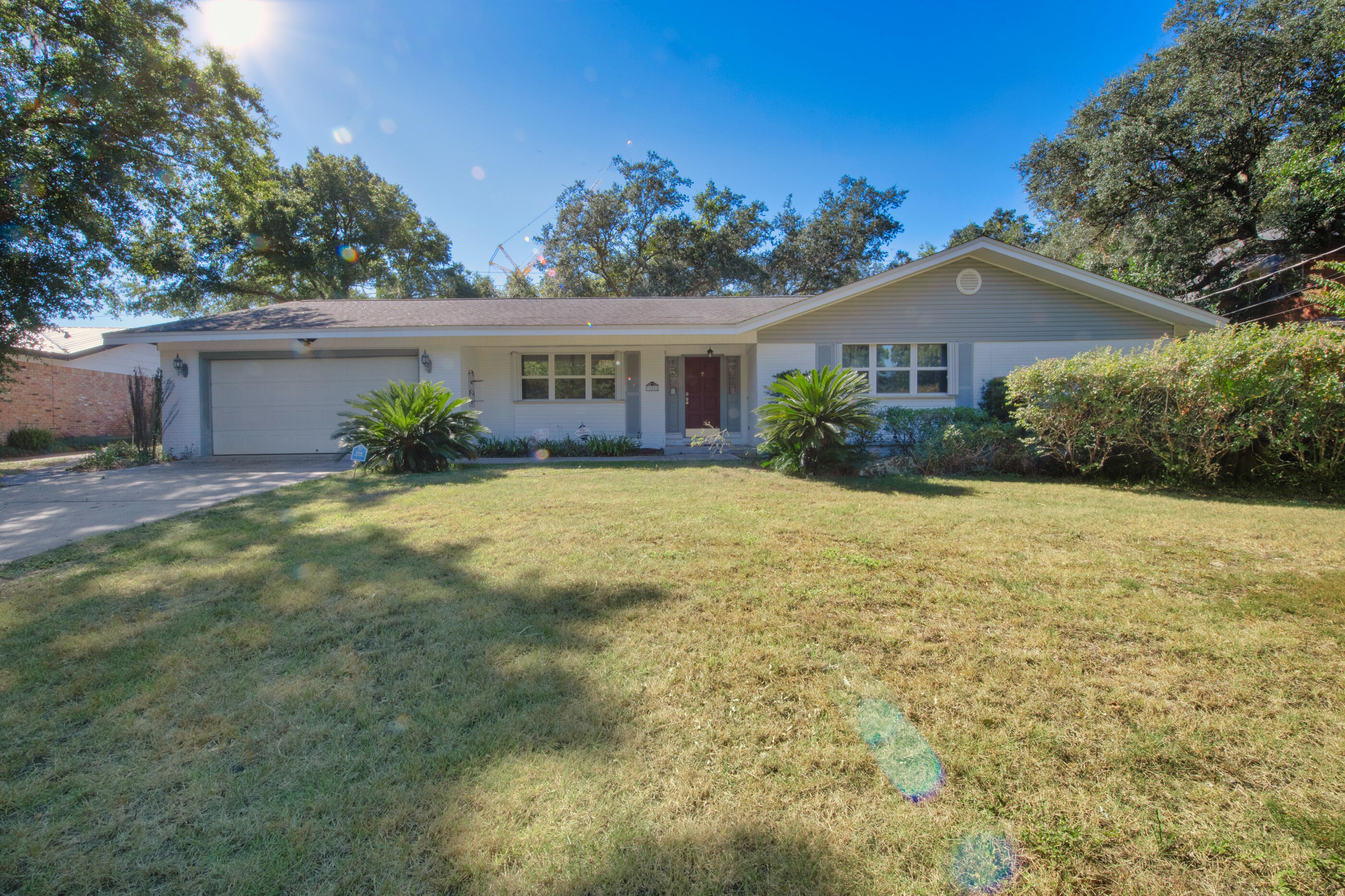 Located in the heart of Fort Walton Beach, this home has extraordinary space. The interior boasts 2 living rooms & a formal dining room with tile floors throughout the living, family, kitchen, dining, hall, and master bedroom. The kitchen has granite countertops, solid wood cabinets and drawers with ample amounts of storage, and a stainless steel gas range with a double oven. The master bath has a tiled shower complete with rain shower and jet system and the master bedroom closet is spacious with additional storage for all of your needs. The home includes an extra large garage, an outside storage building and a whole house natural gas generator. The exterior features a well pump & sprinkler system, fenced in backyard, a front and back porch & established trees for tons of shade.