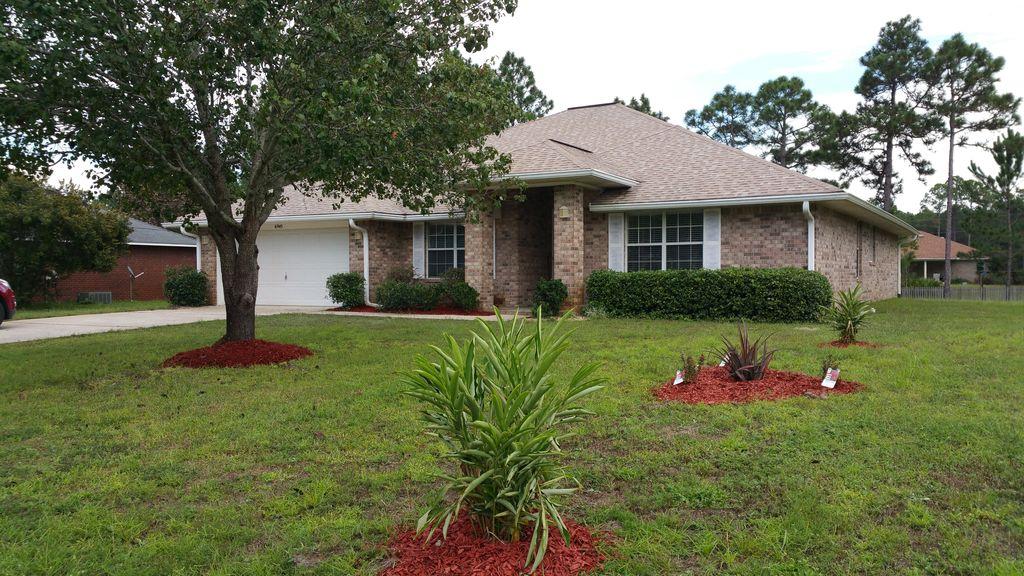 Don't blink or this gem may be gone! This home has been completely renovated with travertine tile flooring, A/C replaced in 2015, high end fixtures, stainless appliances, and corian counter tops!This home boasts an open floor with 2493 sqft of living space,that doesn't even include the giant 2 car garage and a gorgeous sun room makes!The lot is high and dry, and almost half an acre in Holley By The Sea, whose amenities include multiple pools, childcare, tennis courts, beach access, boat launch, and much much more! When you walk into the newly refinished front door of this immaculate home it feels brand new! Large rooms, his and her bathrooms in the master with an enormous walk in closet, formal dining area, you have to see this place to believe it