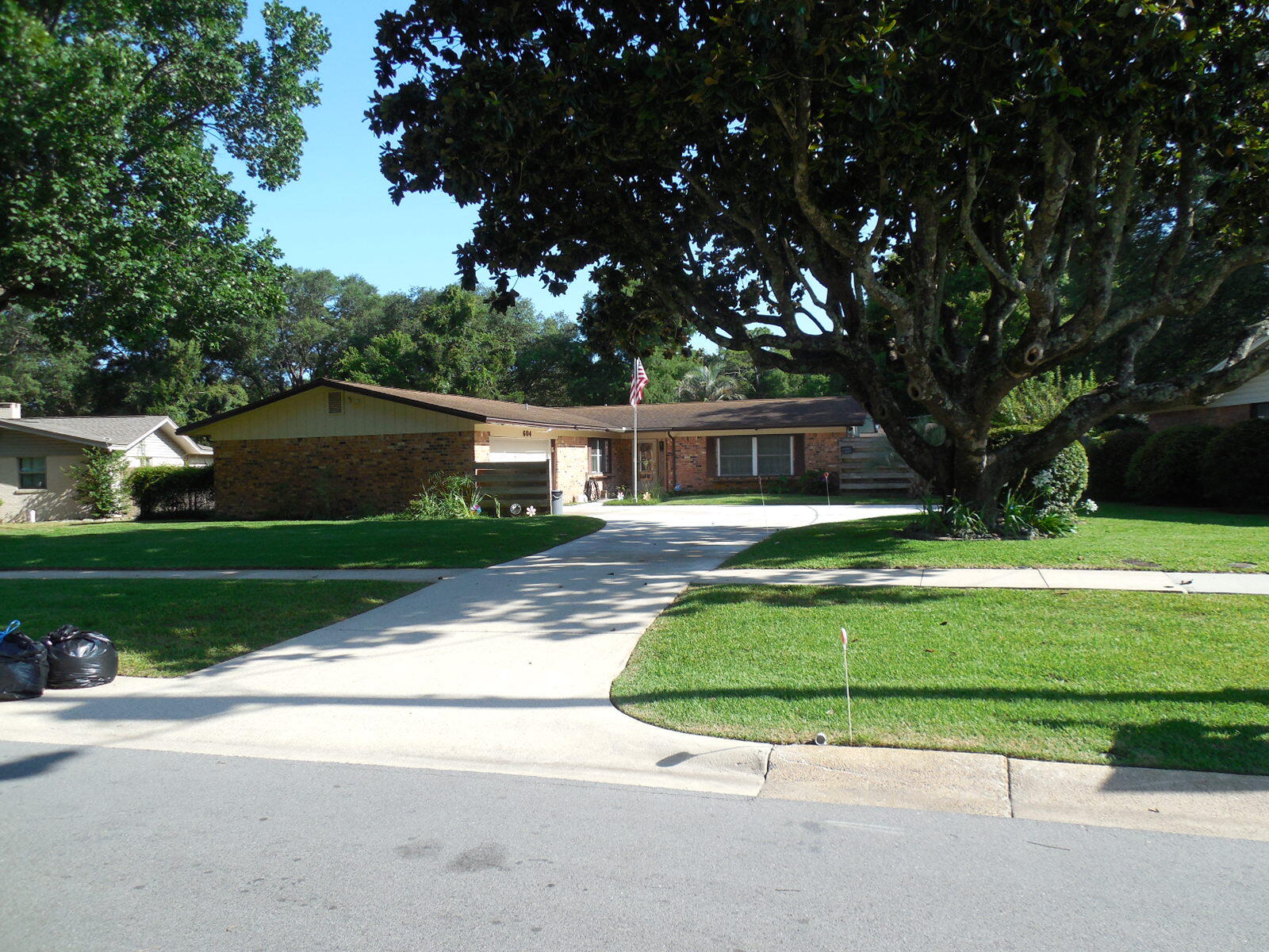 Just imagine owning a home with a pool in the coveted Kenwood Subdivision! This 1889 square foot, 4-bedroom, 2-bath pool home is now available for a new owner. The home and property has been well maintained and meticulously taken care of by the current owner for over 48 years. Inside, you will see the pride of ownership and will find a clean and well-maintained home with 2 separate living areas and a separate dining area adjacent to the kitchen, 4 generous bedrooms and 2 full bathrooms. The windows were replaced in 2009 and they have installed brackets for easy installation of pre-fit storm shutters if bad weather threatens. With a little updating this home could dramatically increase in value and would be a truly magnificent home! Outside, your private paradise waits with a large in-ground pool, ideal for cooling off on warm Florida days and enjoying family get-togethers or entertaining guests. The beautifully groomed yard, adorned with mature trees, offers a serene setting for outdoor enjoyment. Whether you're sipping your morning coffee on the covered back porch or tending to your garden, this space is sure to become your favorite retreat.
You will enjoy the convenience of having a large garage for your vehicles with built in storage closets, a nice work bench and a fixed air compressor with a ceiling mounted air hose reel for the mechanic or hobbyist. In the back yard, there is a well-constructed outside shed with a concrete floor that is equipped with electric power for additional storage, hobbies or extra workspace. There is also a generator on hand that is wired directly into the home and is capable of supplying limited power for appliances and media so you can have peace of mind during any weather.
This home truly blends indoor charm with outdoor tranquility, making it the perfect choice for those seeking both comfort and convenience in their next home. Don't miss the opportunity to make this see this beautiful property and make it your own!