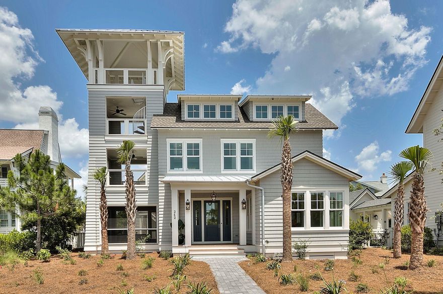 This brand new 5 bedroom beach house including a bonus bunk room and appointed carriage house is located in WaterSound Peninsula and tucked away South of Scenic 30-A on Gulf Bridge Lane. Offering breathtaking Gulf and lake views as far as the eye can see from the fourth floor viewing tower, this home offers coveted first and second floor masters and access to outdoor living off of each of the bedrooms. The backyard oasis features an infinity hot tub, L-shaped pool and outdoor kitchen equipped with a grill, ice maker and mini fridge. The spacious covered front porch greets you as you enter the home's open concept great room with soaring ceilings and beautiful wire brushed oak floors throughout. The large living room offers concrete geometric wall tile that spurs the conversation, recessed