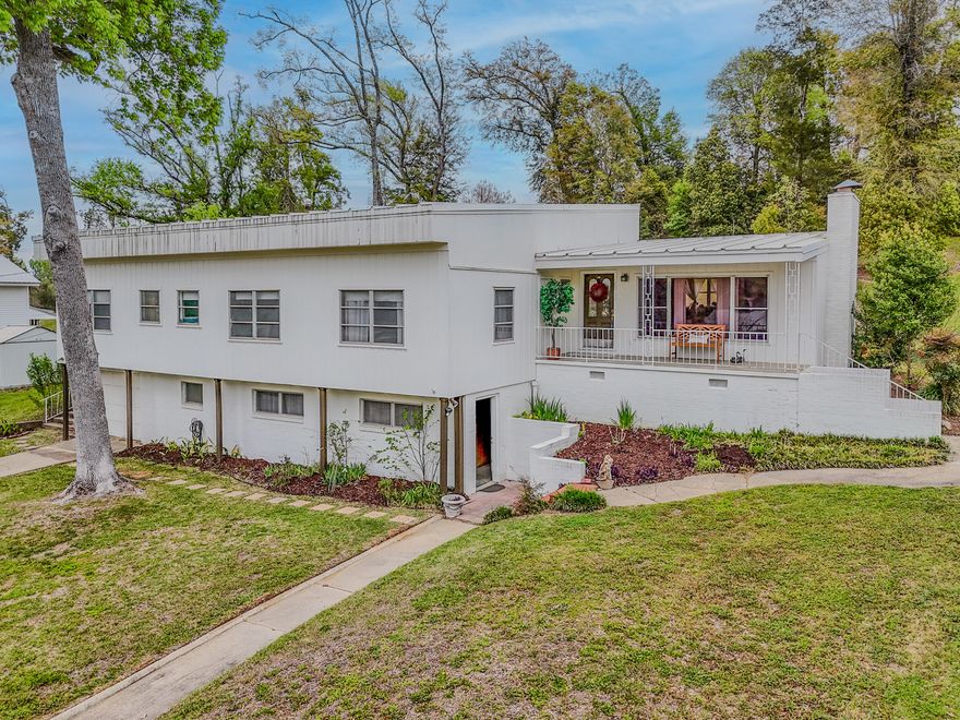 Seller offering $5,000 FLEX Money! Discover this beautifully updated mid-century modern home in a desirable, established neighborhood of Marianna. Set on a spacious 0.42-acre lot with mature trees and lush landscaping, this 3-bedroom, 2-bath residence (approximately 1,870 sq ft) offers timeless appeal with thoughtful modern renovations.Step inside to find an open, light-filled layout with fresh finishes throughout. The expansive living area features warm wood tones, built-in shelving around the cozy brick fireplace, and abundant natural light from large windows overlooking the serene, tree-shaded yard. The kitchen boasts crisp white cabinetry, ample counter space, a double sink, stainless steel appliances, and charming decorative touches that make it both functional and inviting The primary living spaces flow effortlessly, including a generously sized family room perfect for gatherings. The bedrooms are comfortable and well-proportioned, while the bathrooms have been nicely refreshed--one featuring a classic Jack-and-Jill configuration for added convenience.
Outside, the home shines with multiple outdoor living areas: a large wooden deck with dining space and seating, a covered front porch with a welcoming bench, and an expansive backyard offering privacy and room to roam. Enjoy peaceful views of the surrounding greenery, established trees, and natural elevation.
Additional highlights include a one-car garage, practical storage throughout, and a prime location near local amenities, schools, and conveniences while retaining a quiet, country-like feel.
Whether you're looking for a move-in-ready family home or a peaceful retreat with room to entertain and relax outdoors, this charming property on Dogwood Street delivers character, updates, and Florida living at its best. Don't miss the opportunity to make it yours! Property listed in Emerald Coast Association of Realtors.