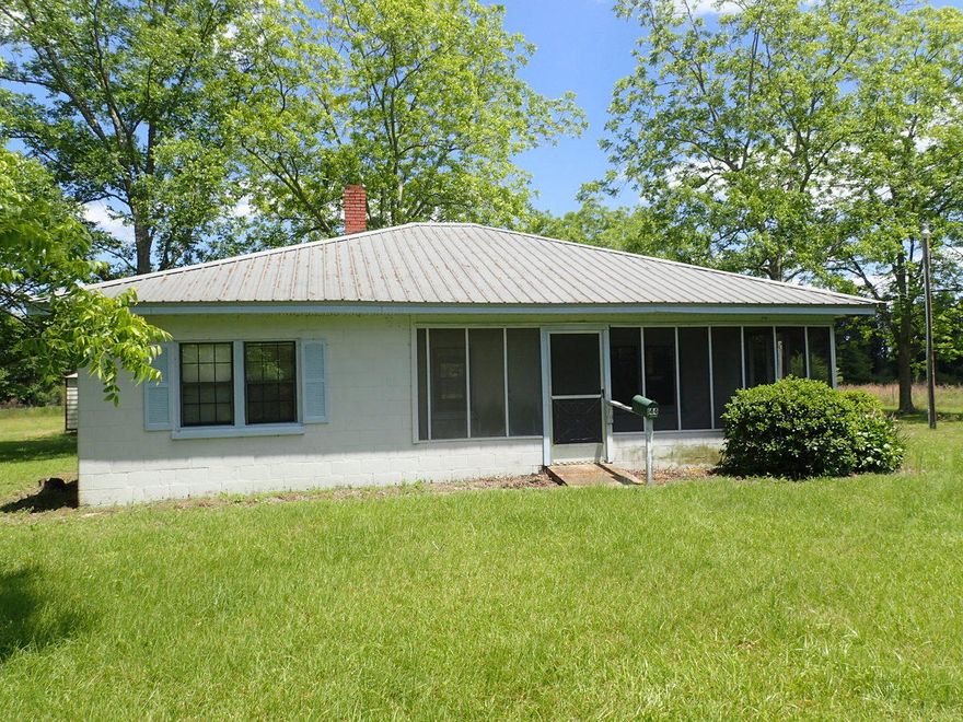 This REO property is country living at its best! You won't find many homes built like this property and in the condition that this property is in. Home needs some minor sprucing up and is move in ready. All block exterior, vinyl trim, large screened in porch and cleared lot. Home comes with extra parking and workshop! Inside the living opens to a very large fireplace, and 2 bedrooms and a bath can be found just off the living room. Kitchen has been updated in the past and presents itself quite well. Indoor laundry room as well. Woodwork and trim is stained and adds to the county fell of the metal roofed solid property. Call today to setup your showing!Property being sold subject to HUD Guidelines 24 CFR 206.125.