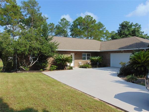 This 2002 Custom lakefront home in Ten Lake Estates is a dream as soon as you enter between the two beautiful cedars into this meticulously landscaped yard. 2172 SF custom brick home sits on a 1/2 acre lot with over 125' on the largest lake in Ten Lake Estates. Interior features include open floor plan, solid surface countertops, tile floor throughout; quality laminate flooring in bedrooms; 27x26 garage. Attached workshop is heated & cooled (would also make a great rec room. 12x30 screened Fl room overlooks dock & lake. Included in the sale: all kitchen appliances, Addtl. fridge & all bolted tools in shop; double Adirondack in FL room; boat w/ trolling motor. Energy efficient home with current avg. bill of under $100/mo. This is a definite must see. Schedule your showing today!