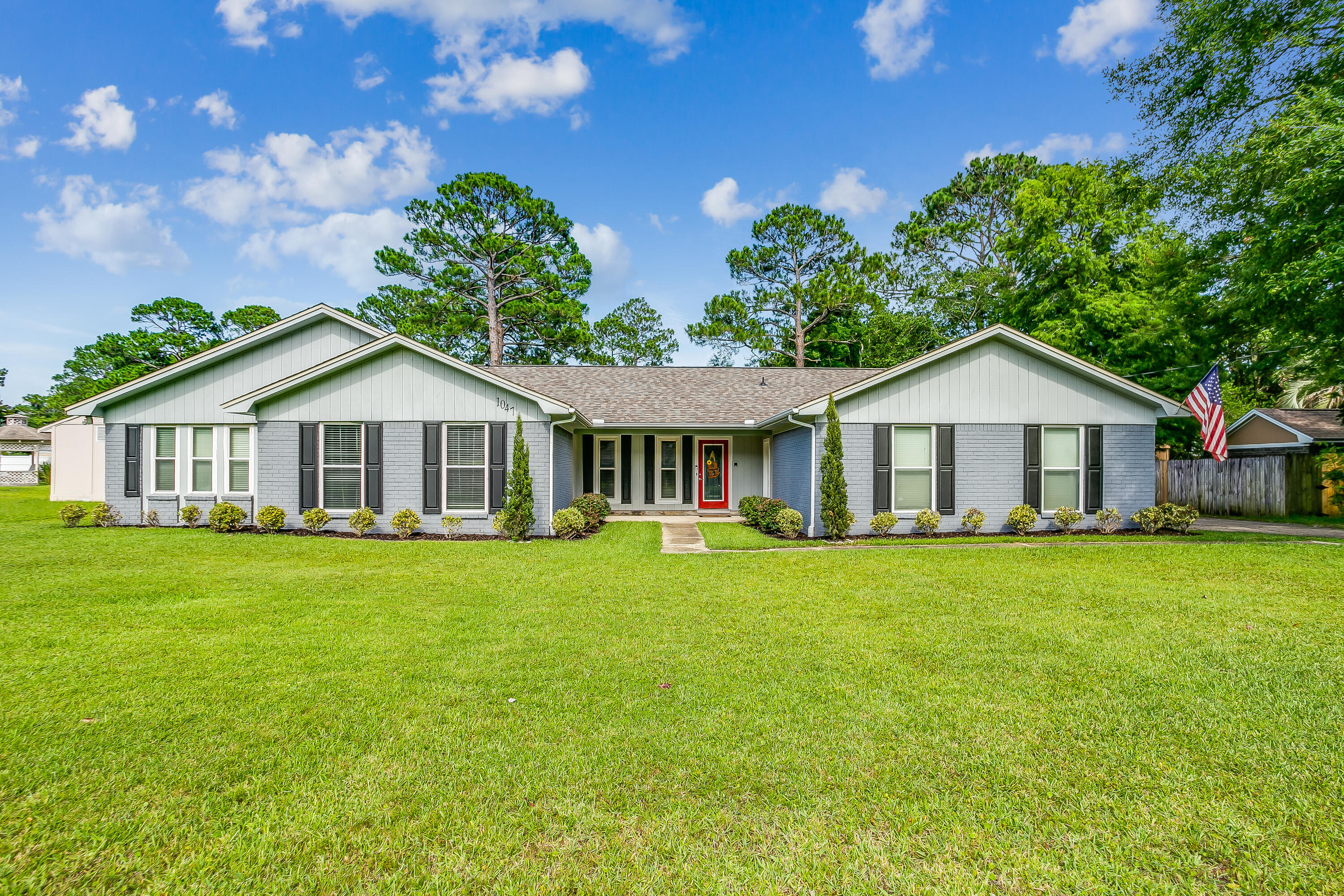 Stunning fully renovated all brick ranch home in Gulf Breeze. This home has been impeccably updated with excellent finishings, everything is new! From the luxury vinyl flooring throughout the entire home to the kitchen built in storage and cabinets, stainless steel appliances, and eye catching tile backsplash. Relax in the large living room where the focal point is the on trend fireplace with a custom wood shelf and soaring ceiling with wood beams. The kitchen walks out to the fenced in, private back yard with an open patio for entertaining. The primary suite has plenty of space, recessed lighting and sliding barn doors. The primary ensuite bathroom is gorgeous with a soaker tub, dual bowl sinks and amazing walk in tile and glass shower, truly a spa feel! Amazing rental income potential!