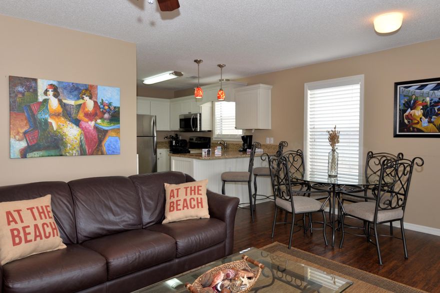 IT'S A GEM! Three bedroom, two bath completely updated second floor condo with a two minute walk to the private beach access  no streets to cross. This unit is projected to gross $25,000 annually & is approved for VA loans. Knock out kitchen with granite counter tops, new stainless appliances, pendant lights, & updated cabinets. Open split bedroom floor plan. Living room & the master bedroom both open to a spacious balcony. Beautiful neutral colors  all floors are hardwood & tile. Bathrooms are also updated with granite counter tops & decorative mirrors. There is a full-size laundry room with washer & dryer. Very nicely furnished, it's a bargain. Enjoy a swim in the pool directly in front of your unit or stroll a short walk down to the deeded beach and feel the waves an