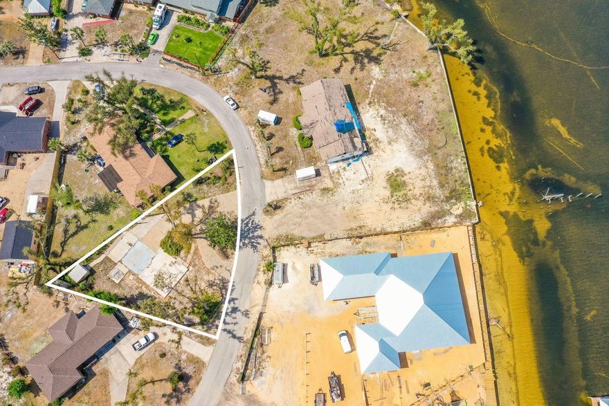 This is a unique opportunity to build a dream home with a bay view in the quiet neighborhood of Donalson Point. Located directly across the street from the bay, this is an approved building lot with a pre-existing slab and brick circular driveway already in place. The property is in between Panama City Beach and Mexico Beach and is conveniently located less than a half mile from the nearby public boat ramp. Just minutes from Tyndall Air Force Base and several Panama City iconic restaurants and attractions, this 13,068 square foot lot offers limitless potential for the right buyer.