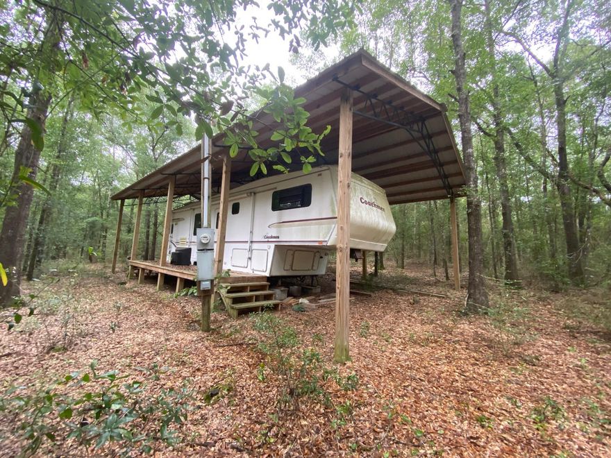 Two 1/2 acre lots for a total of one acre. One lot has power pole, pole barn and RV (no septic or water currently on either parcel). This would be a great place to build your dream home or vacation home. Mobile homes allowed. Public water is available on this street. Septic tank would be required.