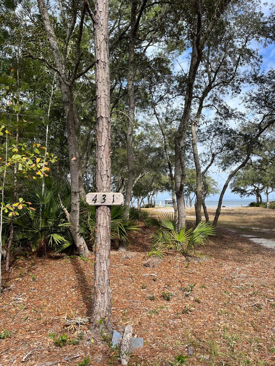 This 100-foot waterfront lot is situated in the Bay Pines Subdivision and offers a private waterfront setting. The lot features a seawall with additional rip rap for added protection, as well as an updated dock with an existing 150 amp electrical panel. The dock includes a covered boat lift that was installed in 2022, and has a capacity of 16,000 lbs. The boat lift is equipped with water and electric run to the dock. The property is cleared and ready for building a bay front dream home.