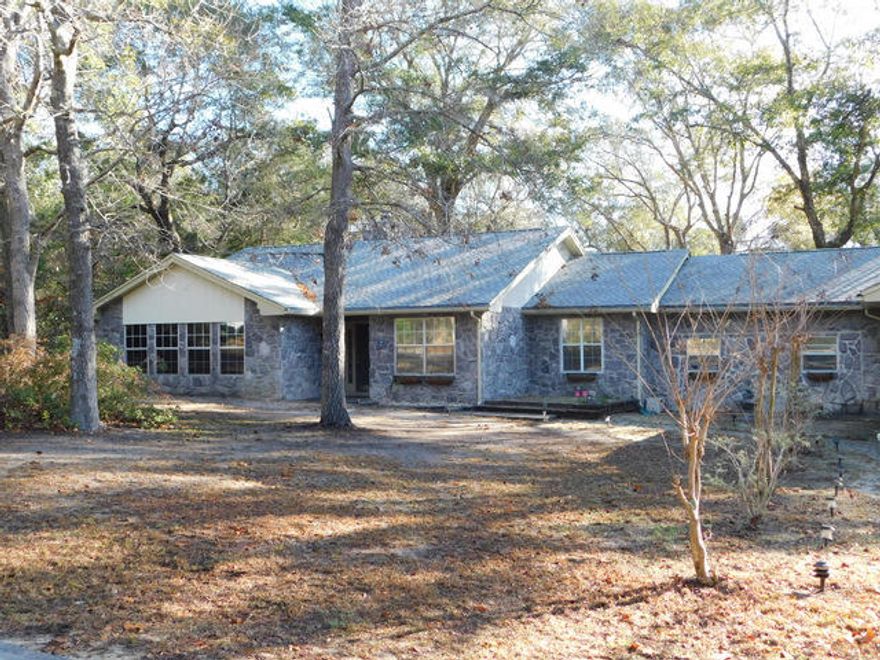 This Lake Sharon Estates home offers 5 bedrooms and 3 living spaces. There is a lot of home and a large lot for a reasonable cost. The home is in need of minor touch ups and upgrades but has so much to offer only 6 miles from Bluewater Bay and the Mid Bay bridge. The lot is level, located on a corner and has quick easy access to the beautiful lakes and the Bay. Inside, you will find a large great room with a stoned, wood burning fireplace, a welcoming Sun room, a game room, a family room and 5+ bedrooms. The master bedroom has a Nursery room or 6 th bedroom attached. This could be used as it sits or converted into a wonderful walk-in closet. The great room has vaulted ceilings and there are 2 HVAC cooling units. The dimensional roof was replaced in 2013 & there is a lawn well outside.