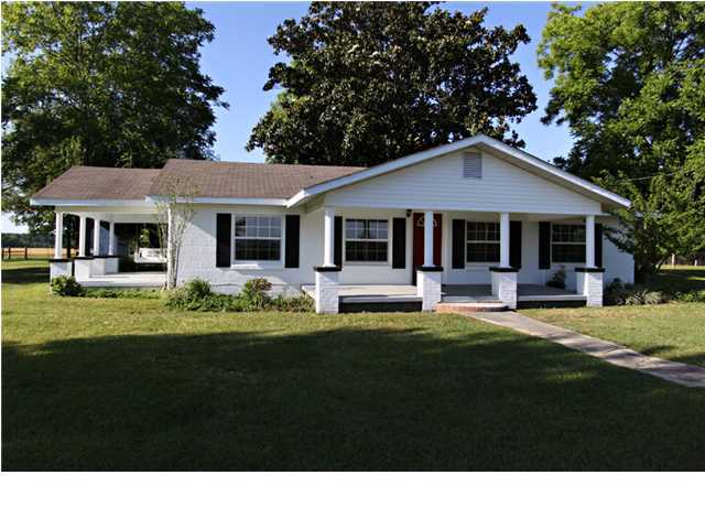 Nice remodeled house has spacious tiled Living Room and large dining room. The entire Home has been remodeled. 4 bedrooms with new tile floors. New paint thru out home. New fixtures. This home has two covered porches to sit and relax on while you look across your beautiful property. The house has a nice, large yard (2 acres +-)with large shade trees. It has easy access and several future home sites. Well priced, it could be the one you are looking for. Don pass on looking at this home. Less than 15 mins to the Interstate. Less than 45 mins from the Beach.