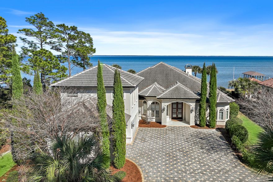 Bayfront Beauty on the Emerald Coast Experience the pinnacle of coastal luxury at this exquisite bayfront estate, set along the sparkling shores of Choctawhatchee Bay in Santa Rosa Beach, Florida. Built in 2013 and exceptionally maintained, this Mediterranean-inspired masterpiece offers the rare blend of timeless design, thoughtful upgrades, and an unmatched location on Florida's Emerald Coast.Primarily a single-level floor plan with a bonus space upstairs, this custom residence spans approximately 3,800 square feet and features 4 bedrooms, 3.5 bathrooms, and an open, light-filled layout that's perfect for both everyday living and elegant entertaining. You'll be welcomed by soaring 12-foot ceilings, stunning wide-plank hardwood floors, abundant natural light, custom built-ins, and a gas fireplaceall creating a warm and refined atmosphere for this luxury home.
The gourmet kitchen is a true showstopper, anchored by an expansive island with seating for 8+ and designed for both function and flair. Features include a gas range, under-counter microwave, ice maker, custom cabinetry, and a breakfast nook with bay views that will take your breath away. Glass doors from the open living space retract to create a seamless indoor-outdoor experienceideal for relaxed Florida waterfront living.
The spacious primary suite is a private retreat with panoramic water views, a cozy sitting area, and a spa-like bath featuring a freestanding soaking tub, oversized walk-in shower, dual vanities, and a custom walk-in closet. This bayfront bedroom oasis is what dreams are made of.
Step outside to your own waterfront sanctuary: a covered lanai with outdoor fireplace and kitchen, a natural gas-heated pool, and a 2017-built dock with a boat lift perfect for sunset gatherings, paddleboarding, or launching a boat right from your backyard. This home is a standout for buyers searching for a waterfront property in Santa Rosa Beach with a private dock and direct bay access.
Additional highlights include a rare 3-car, a paver driveway, whole-home surround sound system, durable stucco construction, and a sleek concrete tile roof. Set on over half an acre, this Emerald Coast estate delivers privacy, sophistication, and direct access to the best of 30A and beyond.
Located just minutes from sugar-white Gulf beaches, five-star dining, boutique shopping at Grand Boulevard (4.7 miles), and award-winning golf at Sandestin Golf & Beach Resort and Santa Rosa Golf & Beach Club, this home sits at the heart of the Florida Panhandle's most sought-after lifestyle destinations. Outdoor lovers will also appreciate nearby Topsail Hill Preserve State Park (6.2 miles), offering hiking, beach access, and natural beauty year-round. The community also features Driftwood Estates Park less than a mile from the home, with tennis, pickleball, basketball, and a playground for everyday recreation.
Santa Rosa Beach real estate continues to attract discerning buyers for its exceptional schools, nationally recognized parks, and world-class coastal amenities. Whether you're seeking a full-time residence or a second home on the water, this property offers an extraordinary opportunity to live in one of the most desirable bayfront locations in Northwest Florida.
Don't miss your opportunity to own a piece of waterfront elegance. Everyday comfort, spectacular views, and the best of beach living await at 1201 Driftwood Point Road.

