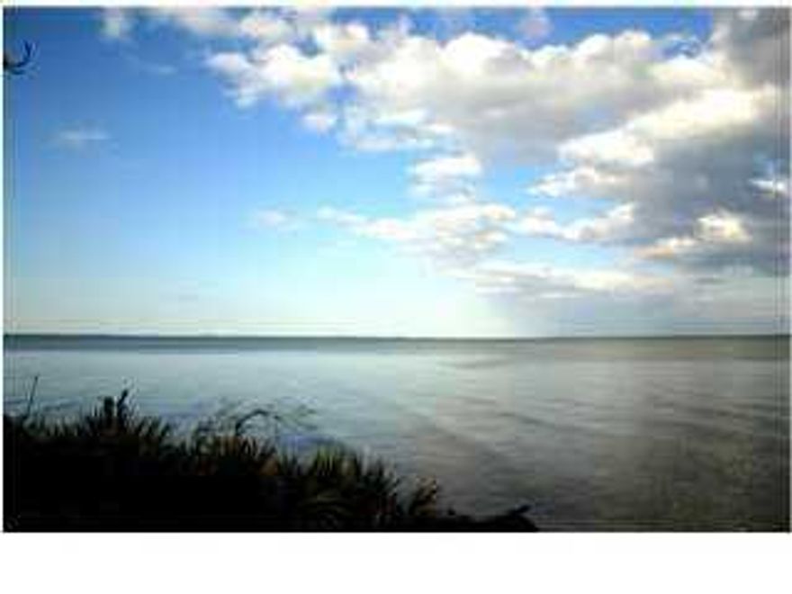 Just reduced and priced to sell!!! Absolute beautiful Waterfront estate lot with amazing westerly views . Over an acre to build your dream house. Large mature trees, a seawall, and a dock are waiting for you.Superb acreage with the coveted westerly views of Driftwood Estates...build your dream home convenient to the area's most prestigious restaurants and shopping, such as Grand Boulevard, as well as the finest hospital along the Gulf Coast, Sacred Heart Hospital