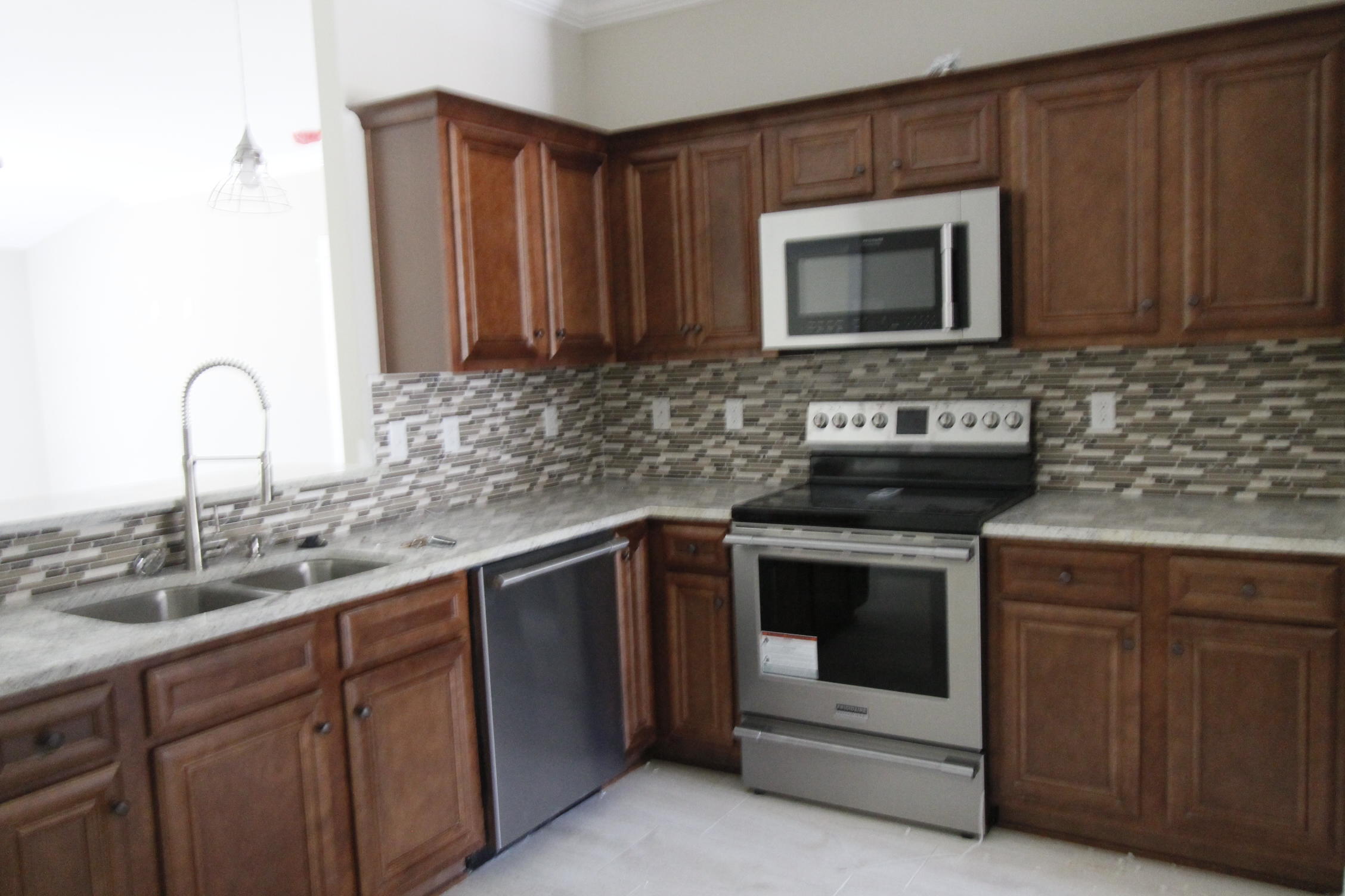 New, custom, 4/3, ''Craftsman Style'' floor plan, with super curb appeal. Great location!! Seller paying most closing costs, with use of approved lender! Tom Street is on the North side of Hwy 98, just 1 minute past the Santa Rosa County line. 10 Ft. ceilings throughout main living areas, as well as tile flooring throughout main/ wet areas. As you enter the home, the dining room is at the left front, of the home. At the rear of the dining room is the kitchen, which boasts custom maple cabinetry, a breakfast bar, granite countertops, a pantry, and stainless appliances, including a refrigerator/ freezer, with ice maker. Master suite has 2 walk in closets, a double vanity, and whirlpool garden tub with separate shower. Large, ''walk-in'' laundry room, is located at the rear of the garage.