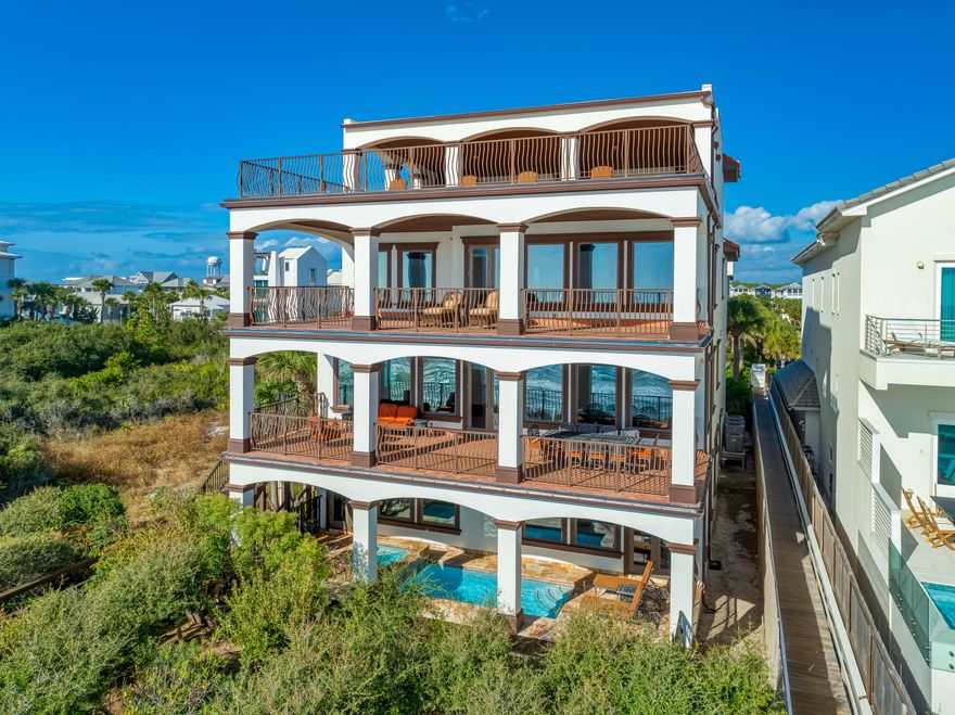 Perfectly positioned between the communities of Alys Beach and Rosemary Beach, this luxurious 6BR/6/2BA Mediterranean-style Gulf Front estate offers an extraordinary beachfront lifestyle within the prestigious, gated community of Santimo Beach, home to just 20 residences. Resting along the pristine sands of 30A's east end, this residence with over 8,000 square feet of living space, an elevator, private pool and spa, and two-car garage combines elegance and privacy with breathtaking Gulf vistas, delivering an ideal setting for those who seek refined living in a truly distinctive setting. Step inside to reveal lavish spaces with Old World charm highlighted by tiled floors, rich wood millwork and doors, plaster walls, custom Wood-Mode cabinetry, luxe tiled bathrooms, designer lighting and much more. The first level includes three spacious guest suites with ensuite bathrooms and a dune side covered porch with heated swimming pool and spa that can be remotely controlled.

On the second level, find the expansive living and dining spaces highlighted by stunning views from a light-filled wall of gulf front, oversized windows. This space features two separate seating areas, one with a cozy stone fireplace plus an elegant dining area flanked by a walk-in 468 bottle wine room. Delighting the most discerning of chefs, the gourmet kitchen offers an oversized breakfast bar, granite counters, a center island constructed of Venus leathered marble, and an extensive suite of commercial grade appliances from Perlick, Scottsman, Viking, and Sub-Zero. Step outside to a covered gulf front balcony spanning the width of the home with direct access to the private beach walkover, newly installed in 2023. The second level also includes a guest suite with ensuite bathroom and a powder room.

An elegant, custom curved staircase leads to the third level which houses the gulf front primary suite bathroom featuring a gas fireplace, sitting area, walk-in his and hers closets, a beverage center, direct access to the gulf front balcony, and a luxe ensuite with double sinks, whirlpool bathtub, and walk-in shower. An office with custom-built bookshelves and a guest suite with ensuite bathroom are also located on this level. 

Ascend to the fourth level and find the crown jewel with an amazing 2,000 SF of outdoor space for entertaining including a summer kitchen, oversized dining table and multiple sitting areas.  The top terrace includes both covered and open decks to enjoy the exceptional sunset and unobstructed beach views.  

With a host of recent upgrades, this exceptional estate embodies the best of sophisticated beachfront living on 30A. From the newly installed private beach walkover to the latest in smart home technology and premium finishes, every detail has been thoughtfully enhanced to elevate comfort and convenience. Whether enjoying sunsets from the beach or one of the expansive balconies, entertaining in the stunning outdoor spaces, or relaxing by the private pool and spa, this home offers an unparalleled retreat in one of the Gulf Coast's most sought-after communities.