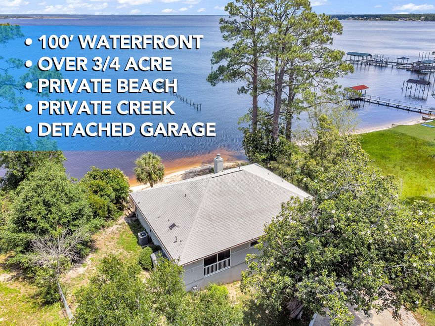 This remarkable waterfront home captures everything you have been searching for: stunning bay views, a detached garage/workshop, 100' of private white-sand beach, and an exceptional price from a highly motivated seller! Resting high on an elevated bluff along Perdido Bay, it offers panoramic water views, a white-sand shoreline, and a proven record of staying high and dry with no flooding history. A peaceful creek winds across the .74-acre property, adding a touch of charm and serenity. Set back from the road and surrounded by mature oaks and pines, the home enjoys quiet privacy while remaining close to everything Pensacola and Perdido Key have to offer. Custom-built in 1995 and lovingly maintained by the same family since, the 2,177-square-foot residence blends open design and thoughtful detail. Vaulted ceilings and large bay-facing windows flood the great room with natural light, complemented by a cozy fireplace. The kitchen includes a large island and newer appliances, ideal for entertaining.

The master suite offers direct deck access, vaulted ceilings, and beautiful bay vistas. Its ensuite bath features a double vanity, jacuzzi tub beneath a skylight, separate shower, and private water closet. A split floor plan separates the two guest bedrooms for added privacy. Above the detached garage, a large bonus room makes the perfect space for an office, studio, or gym. A full set of hurricane shutters protects all windows and doors.

Other recent updates include tile flooring in the great room, a new refrigerator, gas water heater (2018), rebuilt AC (2023), and a roof approximately 15 years old with exterior condenser replaced in 2010.

Whether you envision it as a permanent home or a peaceful waterfront escape, this is a place where memories are made and time slows down. With a private beach and creek, detached garage, and space to expand or personalize, the potential here is as open as the view itself.

Seller is highly motivated and open to ALL offers! Don't miss this opportunity to own one of Perdido Bay's most unique and tranquil waterfront homes.
