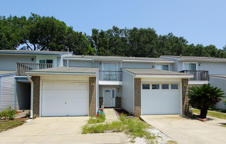 Two-story townhome near the Shalimar Yacht Basin with 2 bedrooms and 2.5 Baths and 1144 sq ft! There is a view of the water from the front balcony! Store your boat and Jet Ski close to your home and take be on the water in less than 15 minutes. This townhome features an attached one car garage, multiple balconies, and a fenced yard! Enter the home and notice the kitchen opens to the living room! The living room features a fireplace and tiled flooring! The kitchen has a slide in stove/oven, microwave, refrigerator, and dishwasher. There is a half bath downstairs for guest! Upstairs there are two large bedrooms and 2 full baths! This town home features walk in closets and ceiling fans! The bathrooms have been renovated with new vanities, mirrors and faucets! There are raised panel doors throughout and sliding glass doors in both the living room and the master bedroom! This town home is so close to the water you can see the water from the front balcony! You can launch a boat just minutes from this home! You can not get a better location than this!  Buyer to verify all information and dimensions!