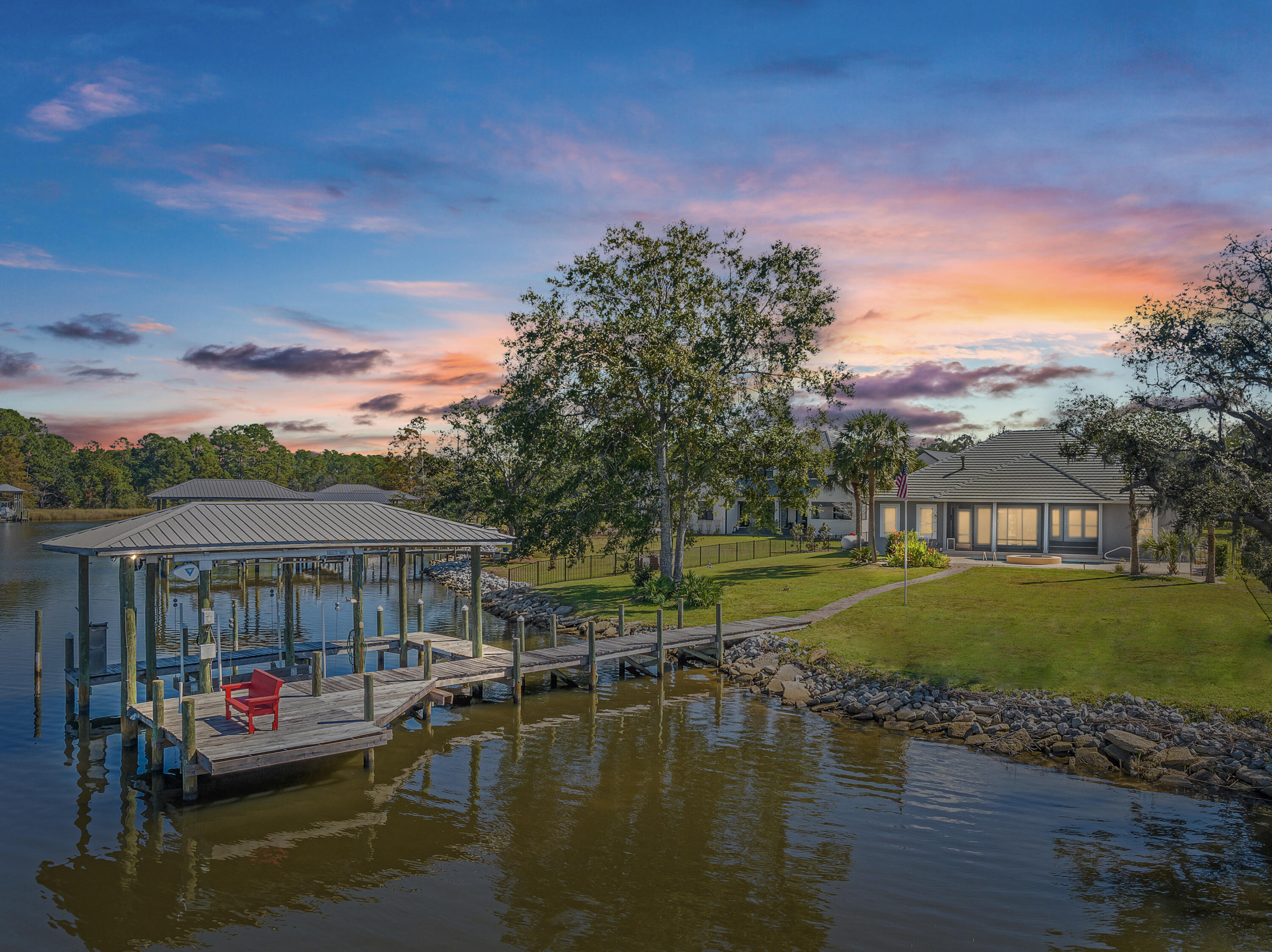 Experience coastal living at its finest in this deep-water bayfront home in the exclusive gated community of Lagrange Cove. With incredible fishing right at your doorstep, this 4-bedroom residence features water views from nearly every room and an inviting open one-level floor plan filled with natural sunlight. Enjoy the convenience of being close to the beach, shopping, and restaurants, then retreat to your peaceful haven where you can savor breathtaking sunsets. Skip the traffic, hop on your boat to local dining spots just 10 minutes away! Enjoy sweeping bay views with over 117 feet of water-frontage. This exceptional property features a boatlift for your watercraft, making it easy to enjoy all that the 'Bay Life' has to offer. Dive into the heated pool for a refreshing swim, even on cool evenings, and keep an eye out for dolphins while fishing right off your dock. It's the perfect blend of luxury and leisure in a stunning bayfront setting! Cozy up by the fireplace in the evenings and embrace the serene lifestyle this home offers. Don't miss your chance to make this slice of paradise yours! Check out the video tour and schedule a private showing today! 