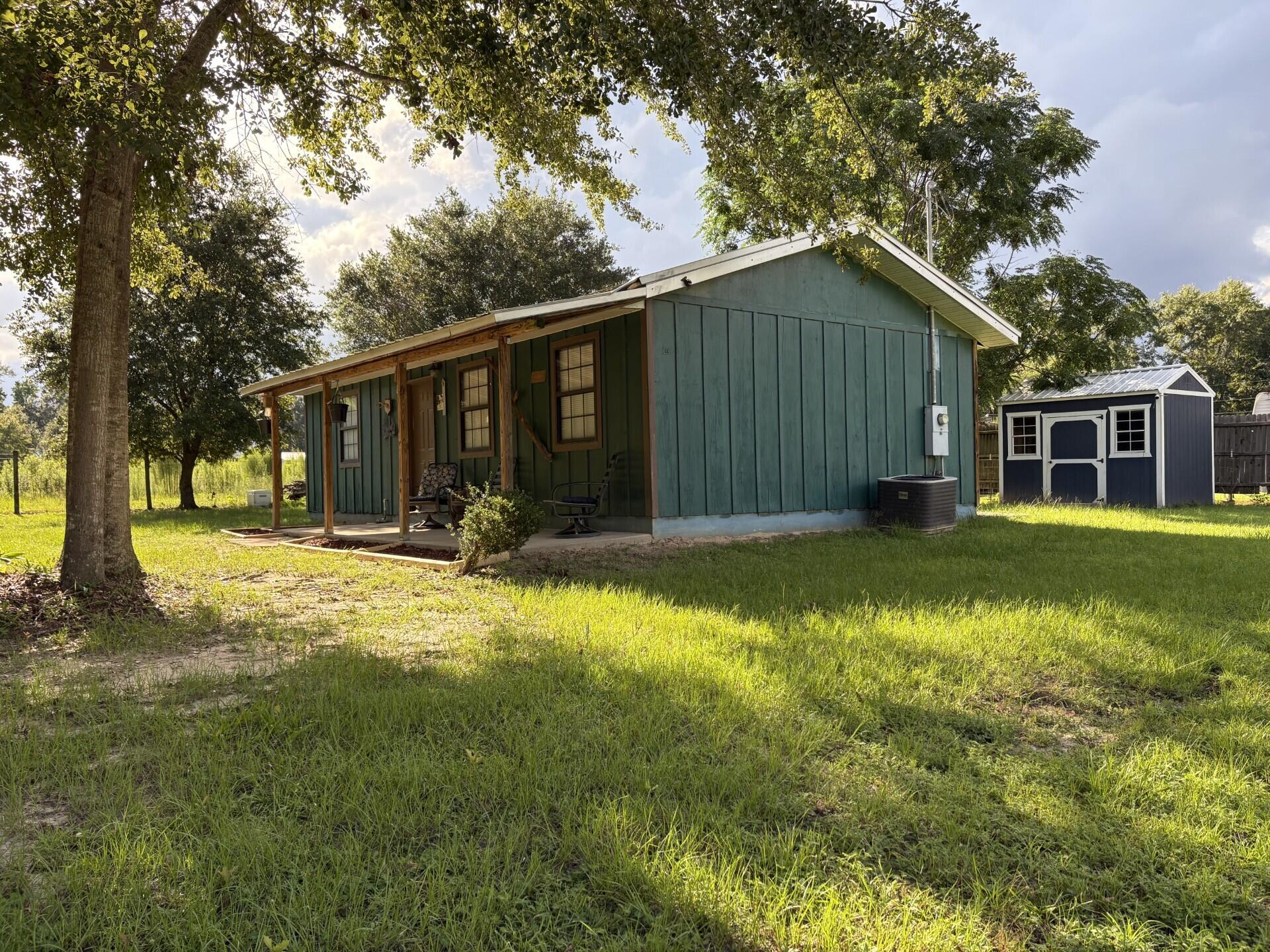 If you love to hunt, fish, run dogs, or simply enjoy the great outdoors, this charming 2 bedroom, 1 bath Florida cottage is ready to welcome you home. Sitting on a .22 acre lot, this comfortable, well kept home offers the perfect blend of functionality and outdoor freedom.Inside, you'll find LVP flooring, modern lighting, and thoughtfully added cabinetry for extra storage. The kitchen comes fully equipped with all appliances, ready for your next home cooked meal after a day in the woods or on the water.The fenced yard provides separation and a safe space for your dogs to roam, while the pole barn and back shed offer ample room for hunting gear, fishing equipment, ATVs, boats, or your favorite outdoor projects.
Surrounded by mature greenery, the property invites gardening, relaxing, or simply soaking in the peaceful setting. Built in 2009, this home boasts a durable metal roof and clean finishes, making it truly move-in ready.
Whether you're looking for a weekend hunting and fishing base or a cozy year-round home, this Florida cottage offers comfort, functionality, and the space to live your outdoor lifestyle to the fullest.