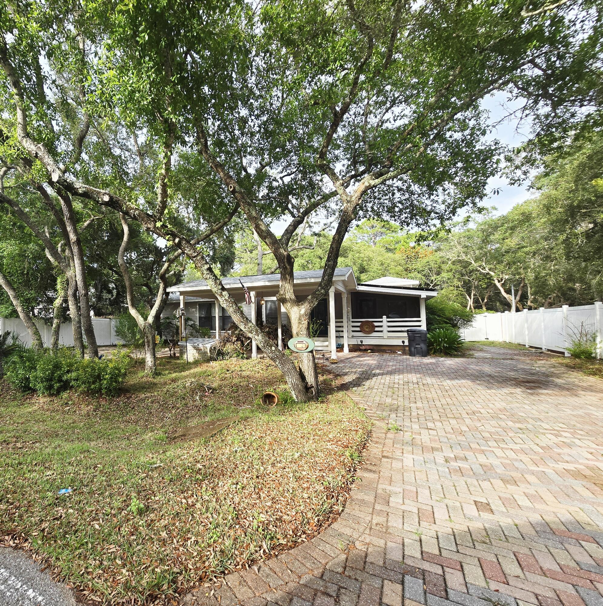 Charming Florida cottage nestled in private quiet lot close to the bay. Brand new deck and 8' vinyl privacy fence all the way around. This home features natural wood flooring with unique molding throughout. Custom kitchen has granite counter tops, stainless steel appliances, and tile flooring. Open floor plan allows for cozy living and dining area. The oversized master suite features walk-in closet, master bath with jetted tub, skylights allowing for lots of natural light and French doors to deck. Guest bedroom features private access to the deck. The third bedroom room features a Murphy-style bed, office desk area, and an abundance of built-in cabinets. Laundry room with front load washer and dryer, as well as secondary refrigerator. This home also includes solar paneling added in 2020.