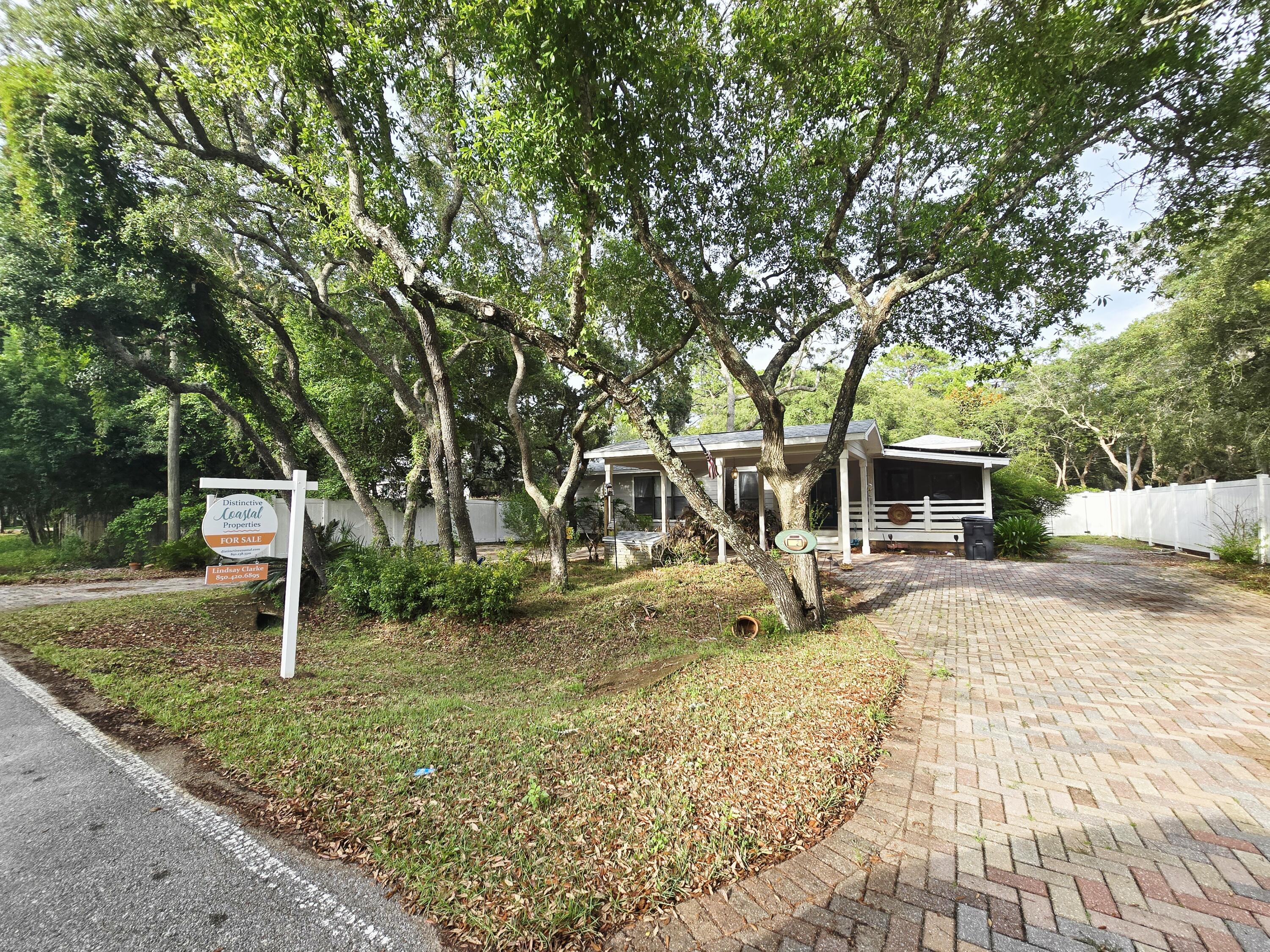 Charming Florida cottage nestled in private quiet lot close to the bay. Brand new deck and 8' vinyl privacy fence all the way around. This home features natural wood flooring with unique molding throughout. Custom kitchen has granite counter tops, stainless steel appliances, and tile flooring. Open floor plan allows for cozy living and dining area. The oversized master suite features walk-in closet, master bath with jetted tub, skylights allowing for lots of natural light and French doors to deck. Guest bedroom features private access to the deck. The third bedroom room features a Murphy-style bed, office desk area, and an abundance of built-in cabinets. Laundry room with front load washer and dryer, as well as secondary refrigerator. This home also includes solar paneling added in 2020.