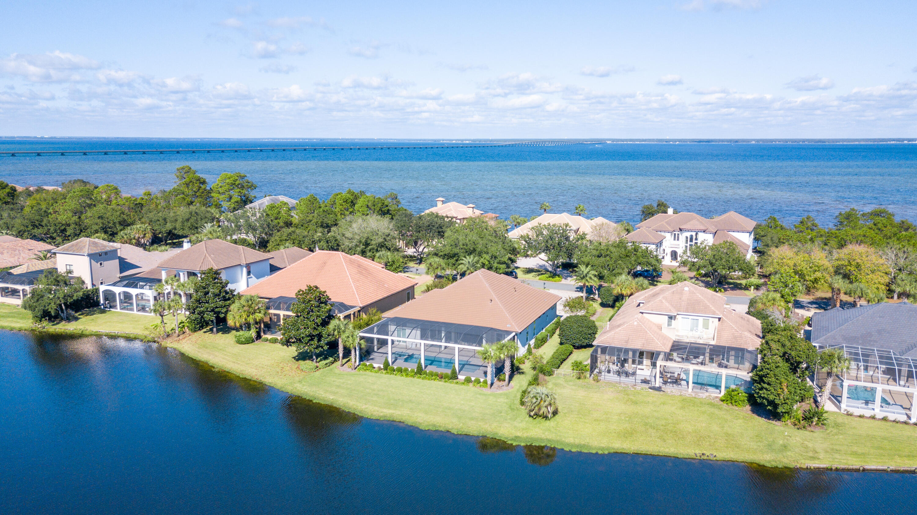 This beautiful lakefront Mediterranean style home is located in the gated golf community of Regatta Bay. This immaculate home is perfect for entertaining. It is situated on a large lakefront lot and offers a 3-car garage, 3510 sq.ft. of heated/cooled space, 4 bedrooms, 3 full baths(the 3rd full bath has access to the outdoor living space), formal living room, family room, gourmet kitchen w/breakfast bar & center island, breakfast nook, formal dining room and wet bar w/beverage cooler, ice maker, sink, extra storage & glass shelving to showcase your finest crystal collections. The screened outdoor living space offers serine views of the lake, large pool, lots of space to relax & soak in the sun, and plenty of covered space to entertain family & friends. This home won't last long!