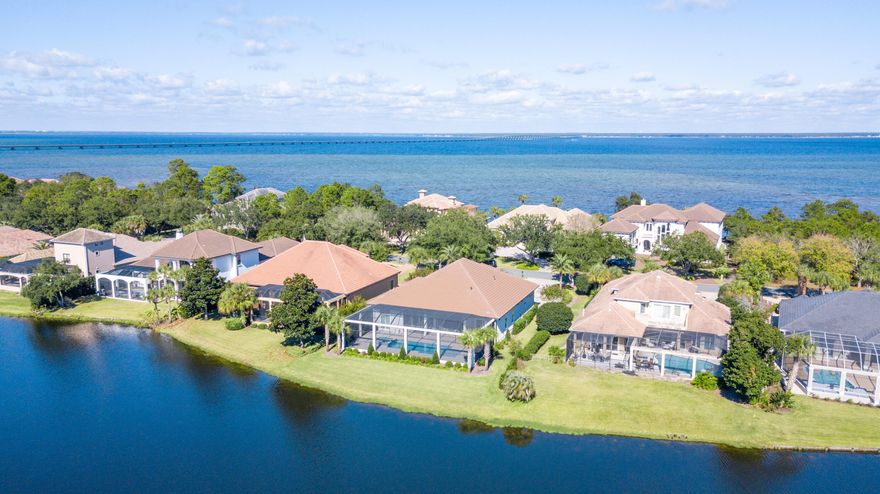 This beautiful lakefront Mediterranean style home is located in the gated golf community of Regatta Bay. This immaculate home is perfect for entertaining. It is situated on a large lakefront lot and offers a 3-car garage, 3510 sq.ft. of heated/cooled space, 4 bedrooms, 3 full baths(the 3rd full bath has access to the outdoor living space), formal living room, family room, gourmet kitchen w/breakfast bar & center island, breakfast nook, formal dining room and wet bar w/beverage cooler, ice maker, sink, extra storage & glass shelving to showcase your finest crystal collections. The screened outdoor living space offers serine views of the lake, large pool, lots of space to relax & soak in the sun, and plenty of covered space to entertain family & friends. This home won't last long!