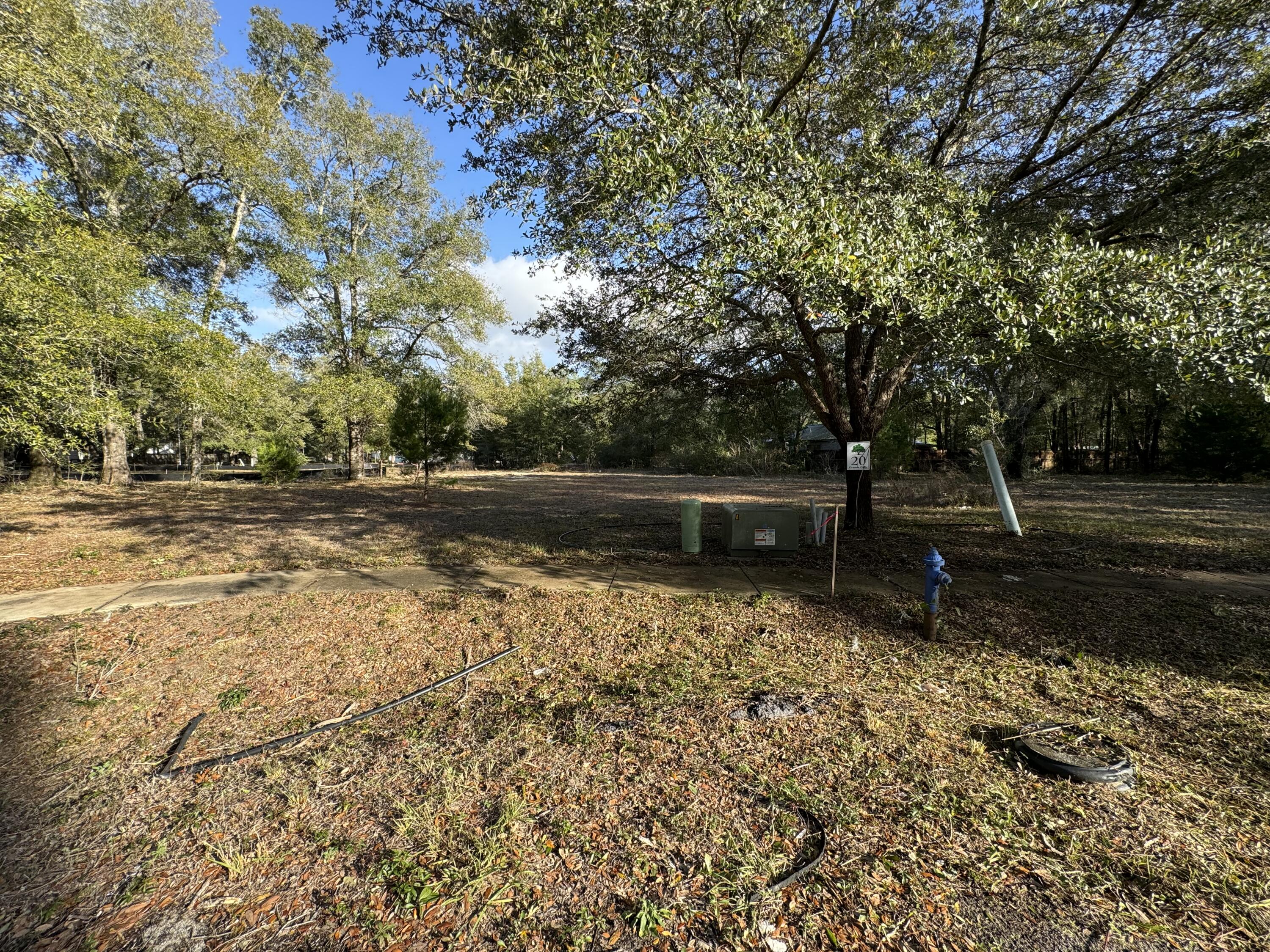 Looking to build a home? Here is a beautifully wooded lot located in the heart of Freeport. This serene community only allows for single family homes. This lot comes complete with permit, engineering and plans, city water/sewer taps paid, and survey. No fill dirt and land clearing needed. (Value $24,100). Everything else has been done for you, providing you wish to utilize the construction plans already permitted for this lot. High-dry lot (Flood Zone X.) is ready to build your dream home, meaning you won't need to pay for costly flood insurance. No mobile homes allowed. Minimal restrictions and HOA is only $75.00 a month.Great fishing on Four Mile Creek, or cruising onto the Choctawhatchee Bay or spending the day on White Sandy beaches of Florida's Emerald Gulf Coast. This amazing property is centrally located between Fort Walton Beach and Panama City Beach offering so much in the way of fun in the sun, tourism activities and Destin's World-Famous Crab Island all within a short 30-45 min drive.
Information contained within this listing such as square footage, property measurements, etc are deemed to be accurate, but is not guaranteed. Buyer to verify.