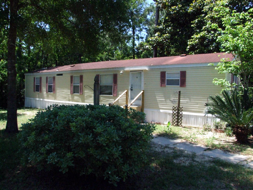 This comfortable mobile home is on a quiet lot (fenced)just minutes from the Bay. It is an open concept with a large kitchen (laundry closet incl.) and living room. New paint, new toilets, new heat pump,recent shower in MBath and recent laminate in living rm. hall, and Mbed. This is a perfect starter home/investor rental that is priced to sell. See it today! Buyer to confirm all measurements and is responsible for registration of mobile home and taxes each year. PROPERTY TO BE SOLD ''AS-IS''!